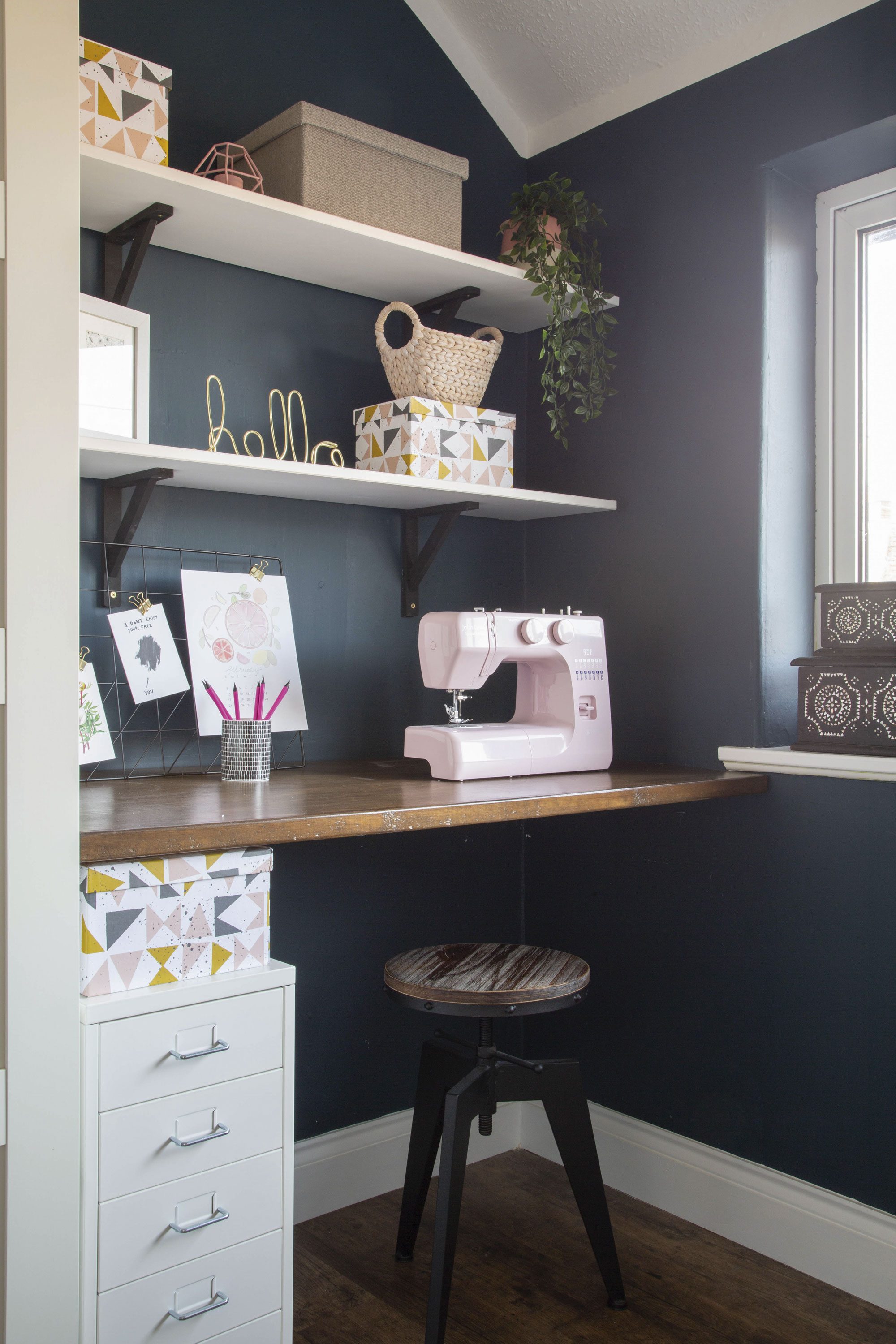 Ruth chose Farrow & Ball’s Hague Blue for the office walls to give it a rich and elegant appearance and added contrast with white shelving and storage. ‘The desk is made from a piece of plywood that I stained and David mounted to the wall,’ Ruth says. ‘It’s simple and sturdy’ Ruth chose Farrow & Ball’s Hague Blue for the office walls to give it a rich and elegant appearance and added contrast with white shelving and storage. ‘The desk is made from a piece of plywood that I stained and David mounted to the wall,’ Ruth says. ‘It’s simple and sturdy’