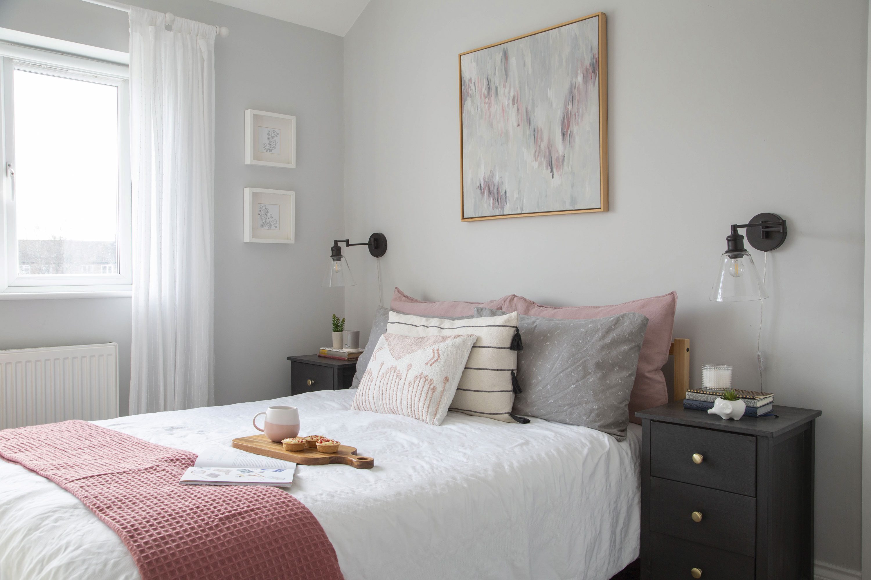 Ruth and David turned what was originally a closet into an upstairs loo and painted the walls of the main bedroom in Farrow & Ball’s Dimpse, a blue-toned grey. ‘I chose to keep it light and airy with crisp white bedding and pink cushions and accessories,’ Ruth says. ‘I painted the artwork above the bed using tester pots of paint used around the house to ensure it would be a perfect match’ Ruth and David turned what was originally a closet into an upstairs loo and painted the walls of the main bedroom in Farrow & Ball’s Dimpse, a blue-toned grey. ‘I chose to keep it light and airy with crisp white bedding and pink cushions and accessories,’ Ruth says. ‘I painted the artwork above the bed using tester pots of paint used around the house to ensure it would be a perfect match’