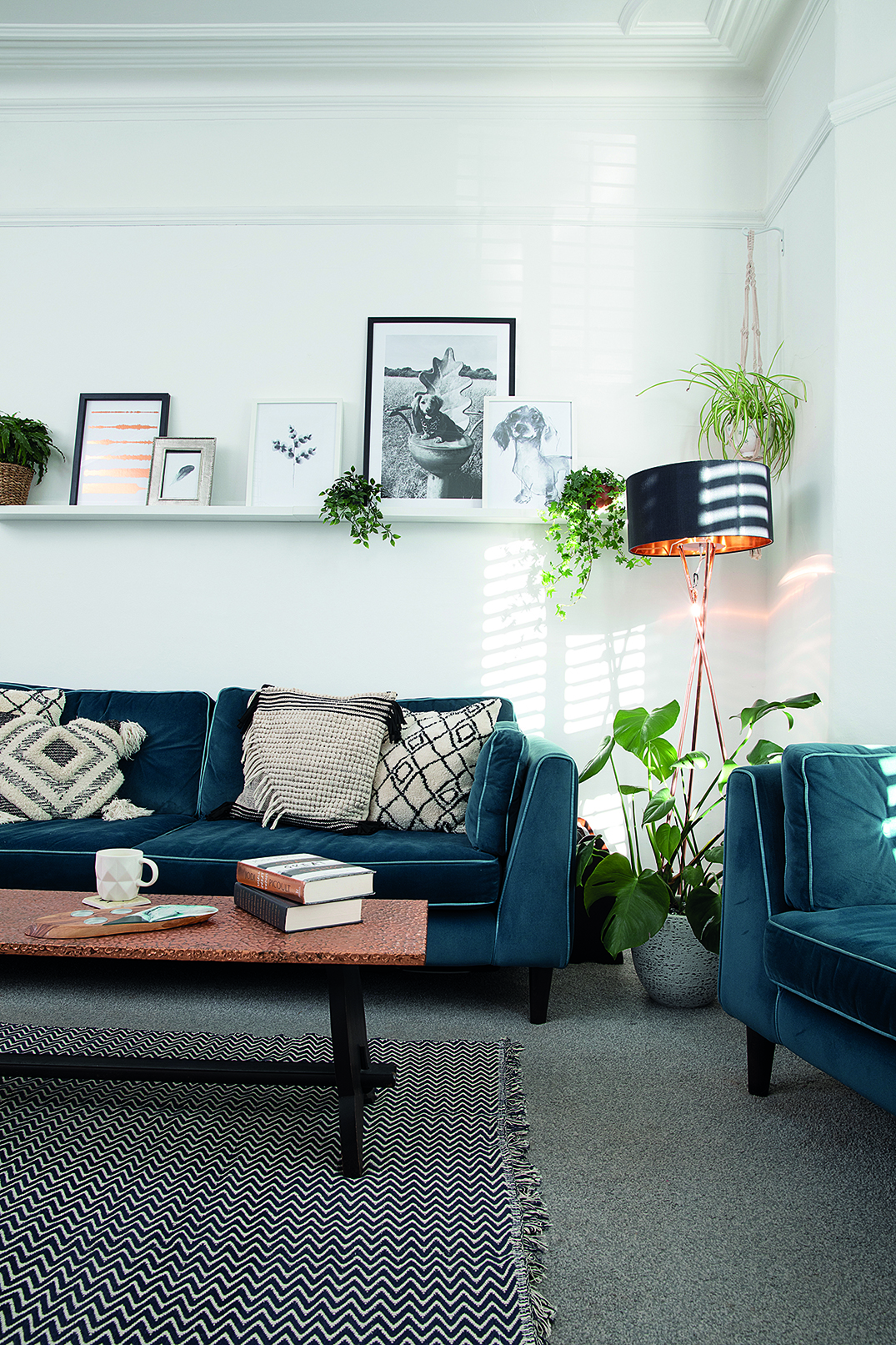 Boho cushions from Next work well with the industrial-look copper floor lamp from Wayfair. ‘Most of the artwork was found online and printed off for free,’ says Charlotte Boho cushions from Next on a blue sofa