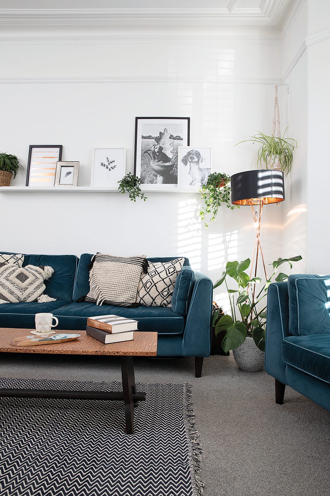 Boho cushions from Next work well with the industrial-look copper floor lamp from Wayfair. ‘Most of the artwork was found online and printed off for free,’ says Charlotte Boho cushions from Next on a blue sofa