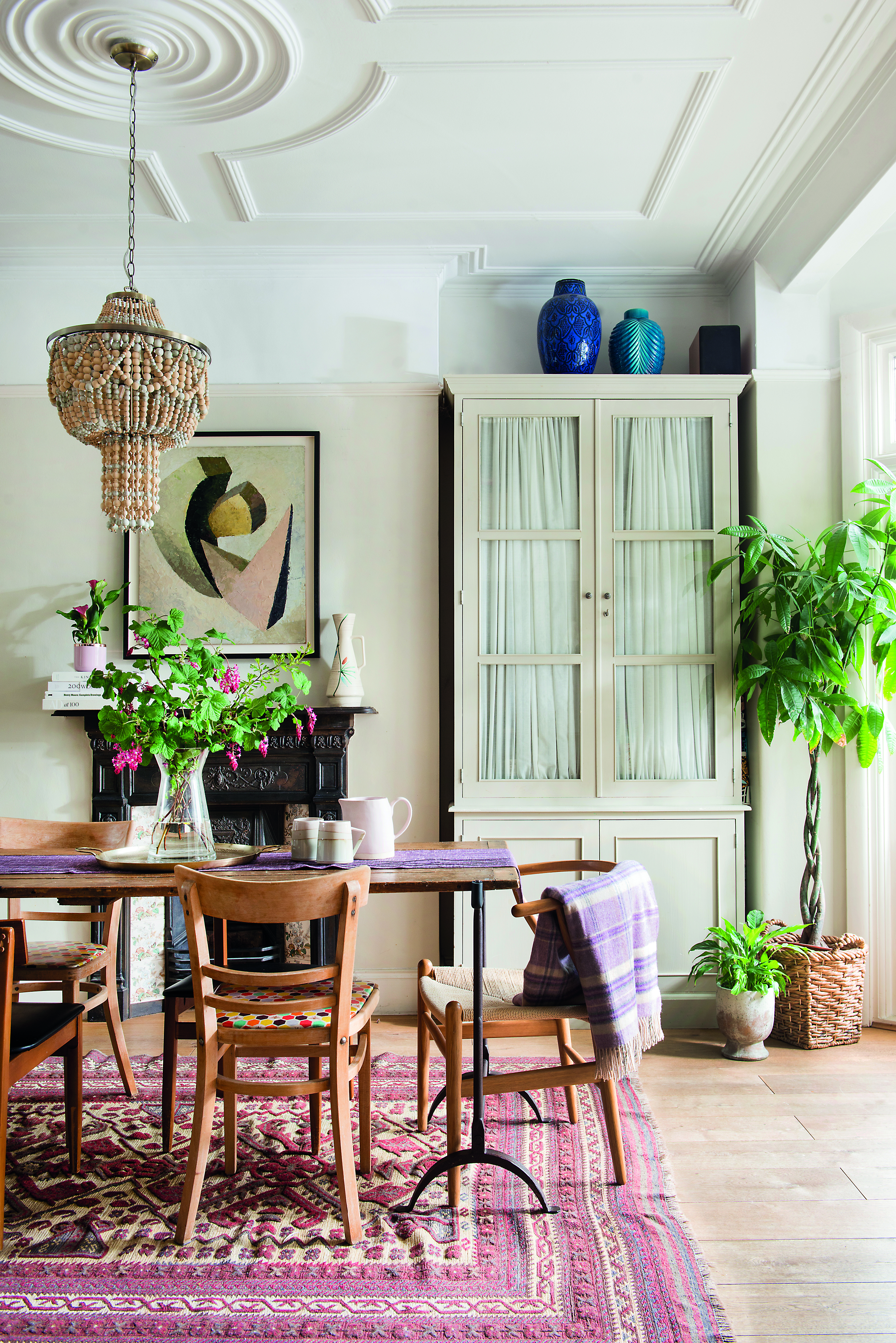 ‘We got our dining room table on eBay’, says Sophie. ‘The top is a reclaimed French barn door, which we’ve protected with varnish. The old pendant light above was too small and didn’t have enough impact, so I replaced it with this fabulous beaded one from Matalan’