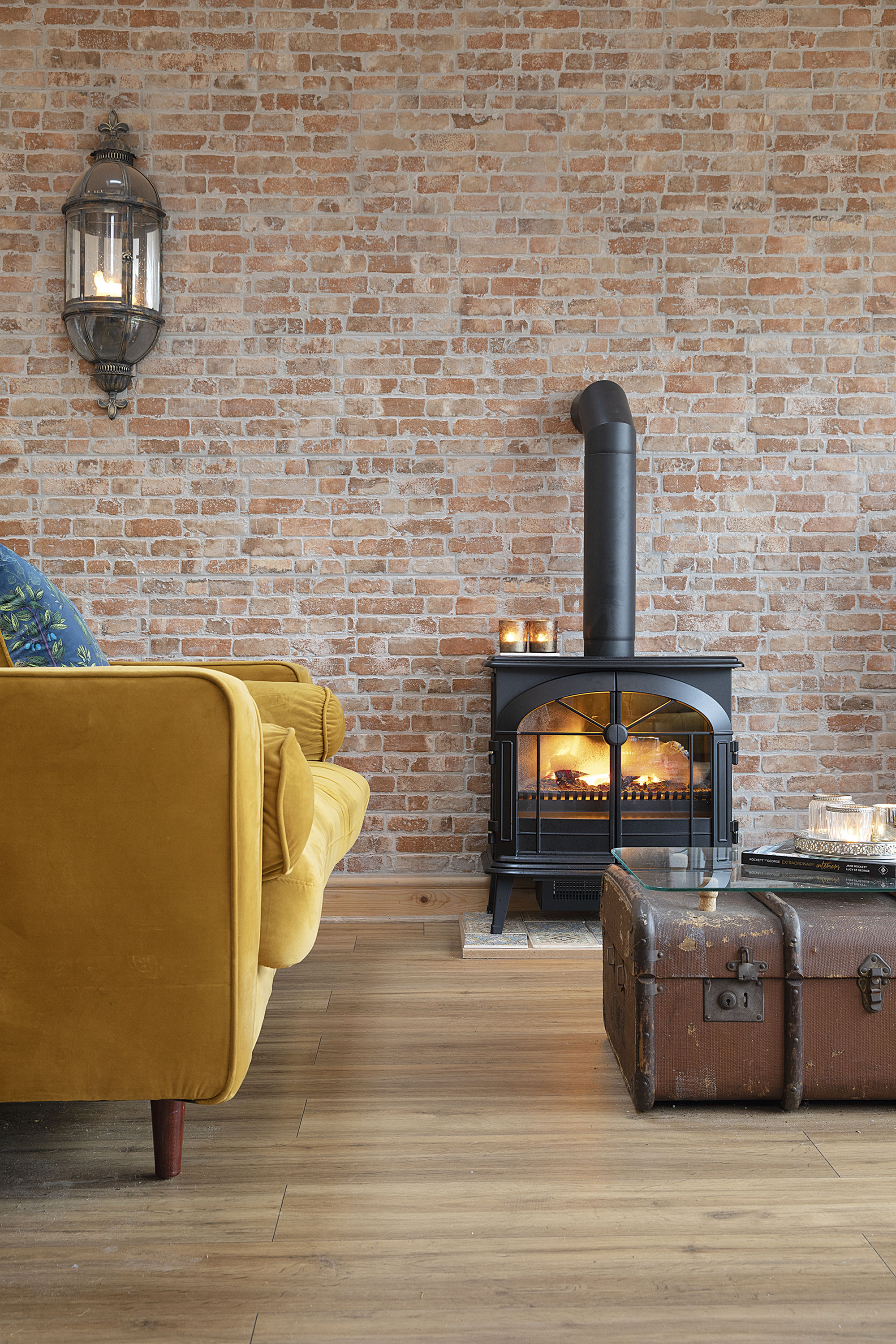 The faux brick wall is home to Sandra’s electric stove. ‘I put in a fake flue at the top to make it look like a real wood-burning one. It makes this space so cosy’ The faux brick wall is home to Sandra’s electric stove. ‘I put in a fake flue at the top to make it look like a real wood-burning one. It makes this space so cosy’