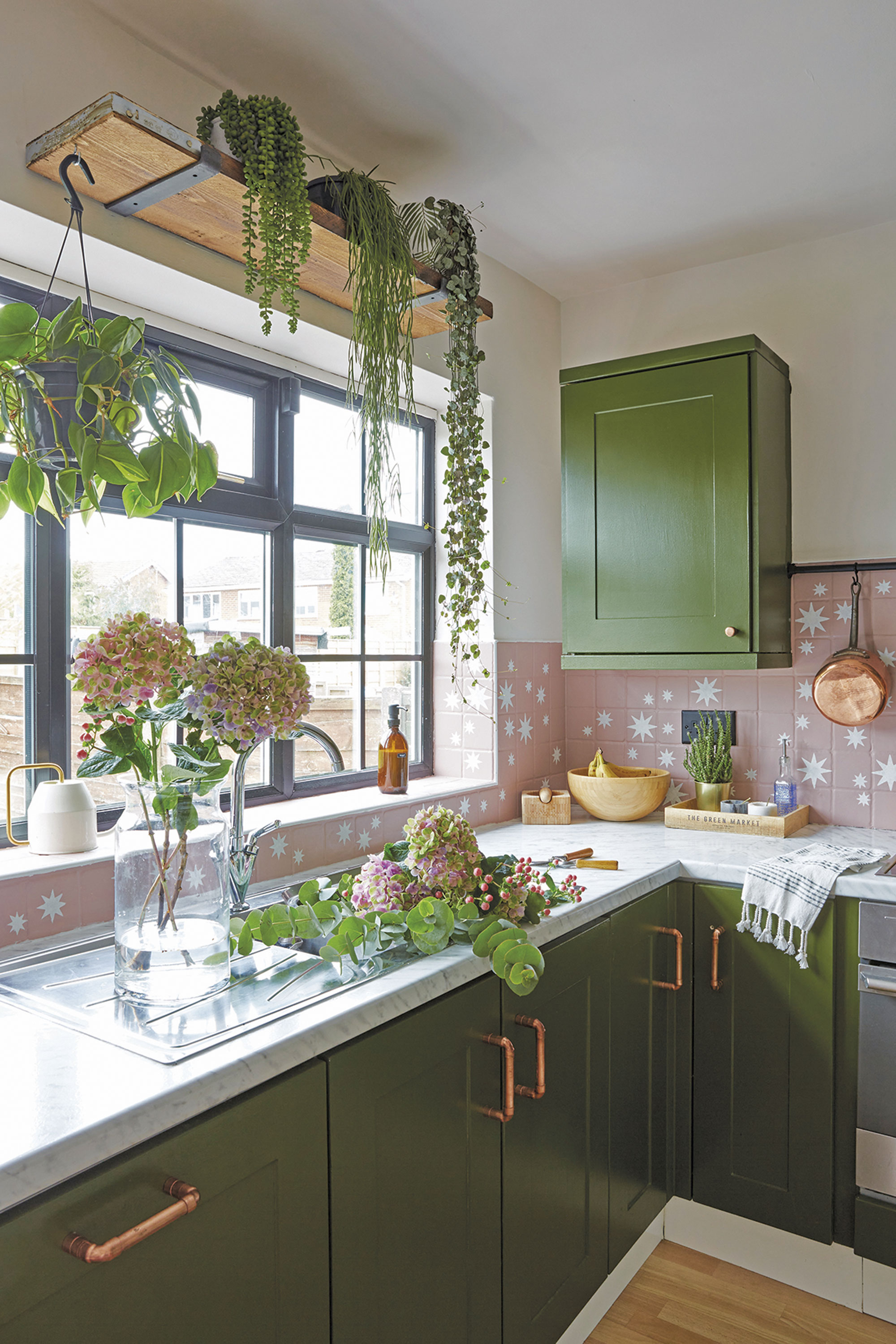 ‘I painted the window frames black as they were typical uPVC white before. I wanted to create a Crittall- style window look and I’m so happy with the result! The shelf above the window was a floorboard I got from B&Q and I love being able to hang plants from it’ ‘I painted the window frames black as they were typical uPVC white before. I wanted to create a Crittall- style window look and I’m so happy with the result! The shelf above the window was a floorboard I got from B&Q and I love being able to hang plants from it’