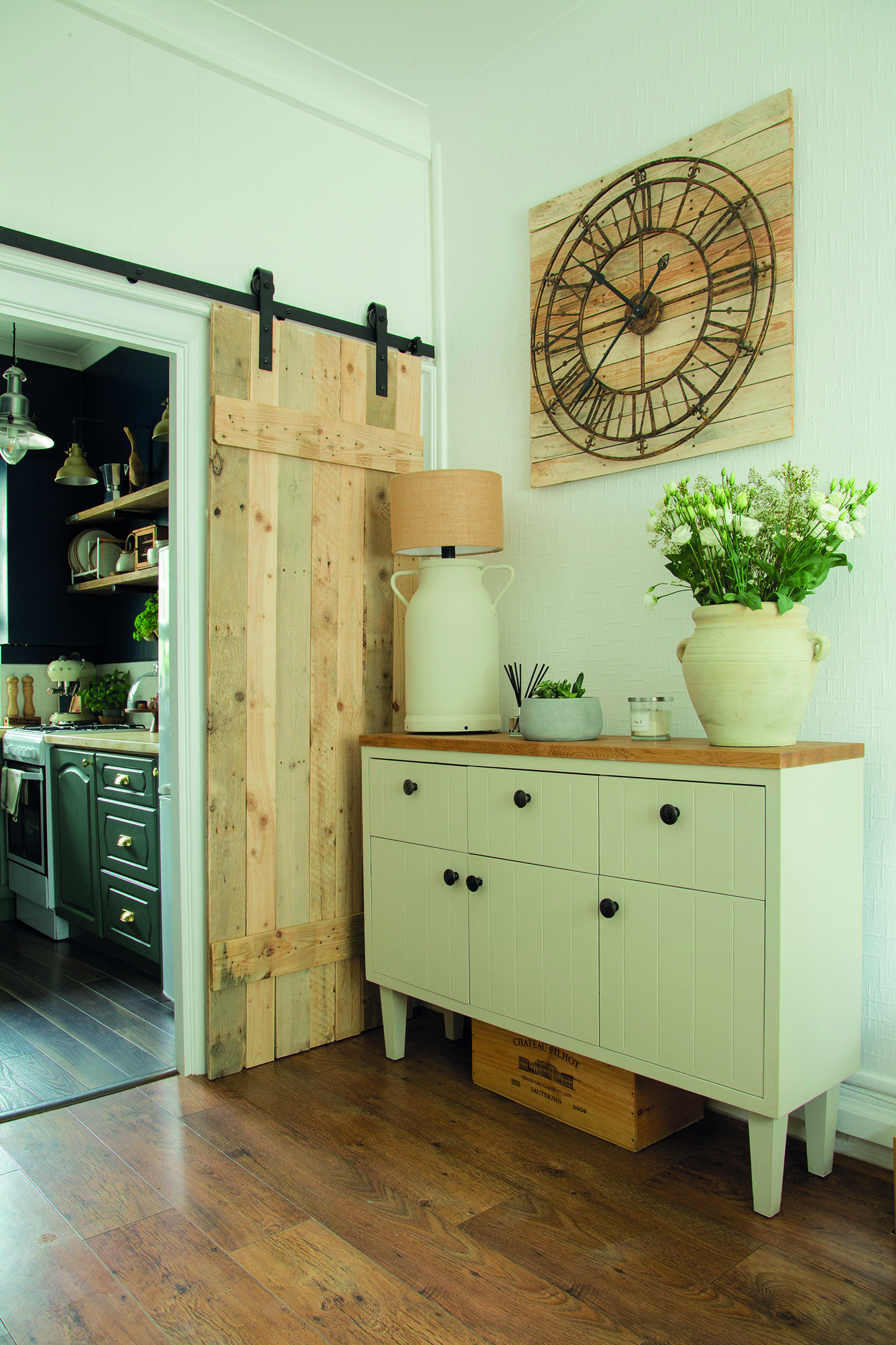 Tosia and Tomasz built the space-saving sliding door from an old wooden milk barrel and made the kooky lamp base using a metal milk churn