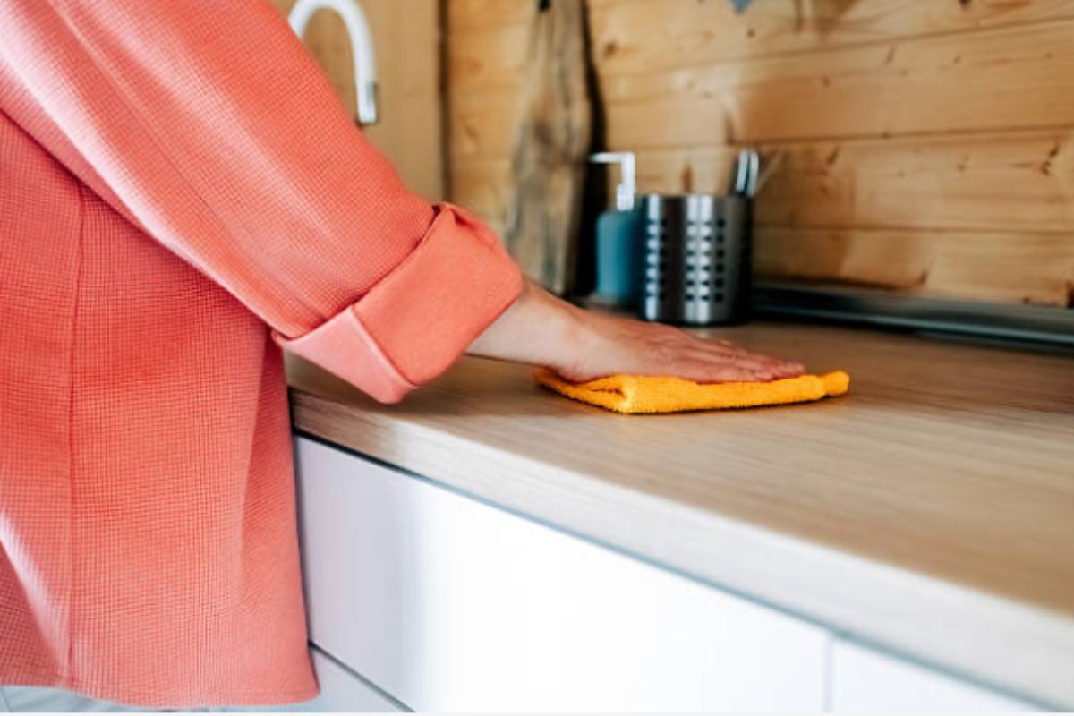 Person wipes kitchen surface