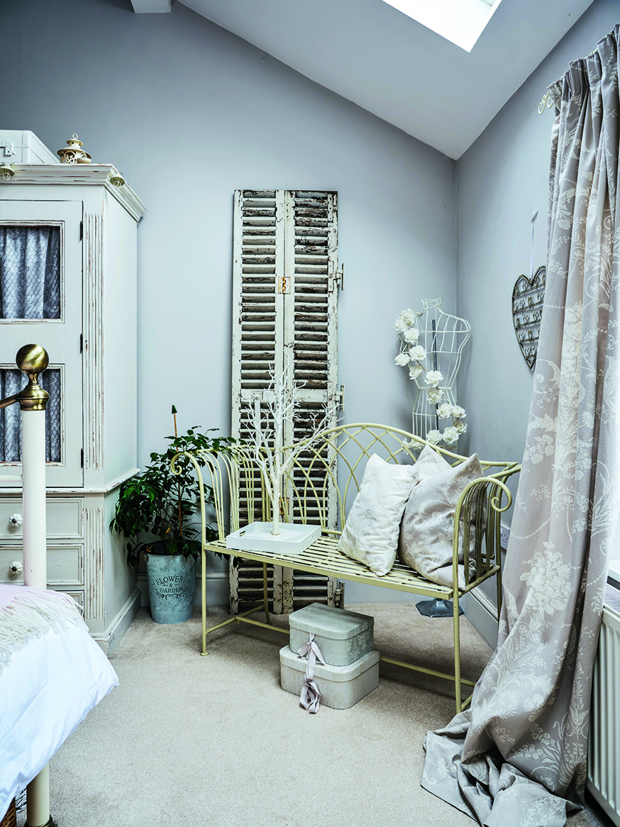 Vintage shutters and a metal bench give this corner of the bedroom a rustic-chic, French farmhouse feel Vintage shutters and a metal bench give this corner of the bedroom a rustic-chic, French farmhouse feel