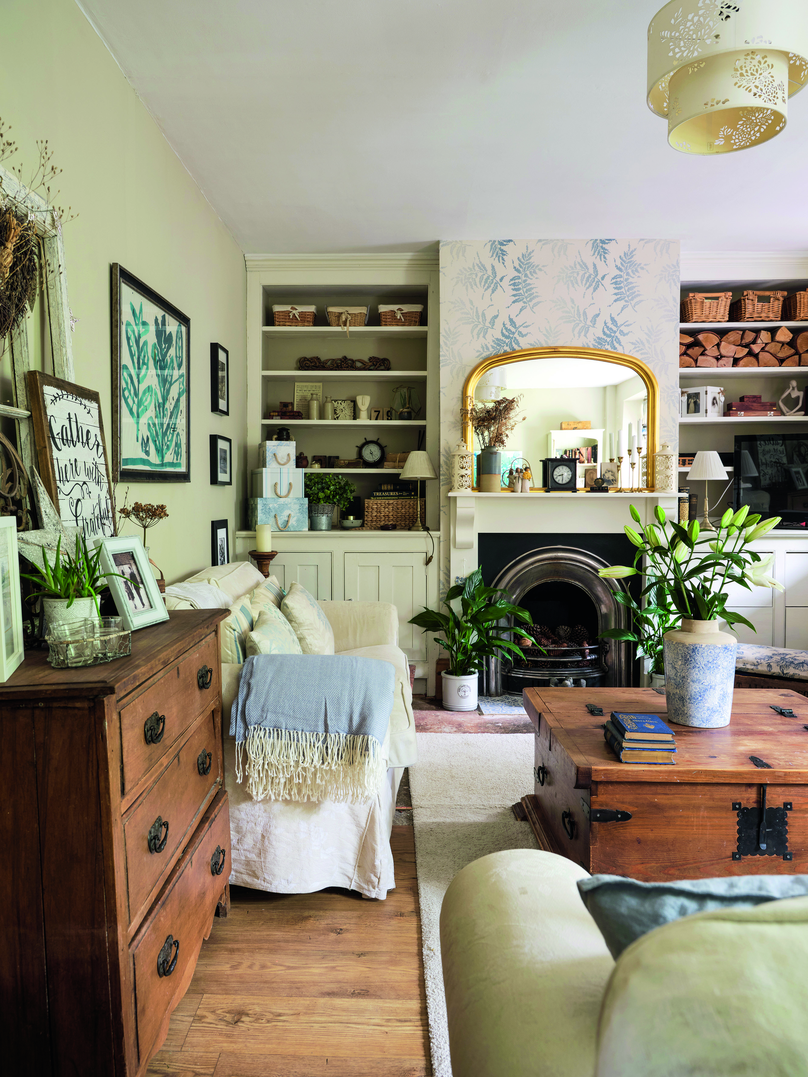 Originally two rooms, the lounge is now one big family space filled with traditional charm. ‘We also reinstated the fireplace and painted the orange pine woodwork to create a more restful feel,’ says Ali Originally two rooms, the lounge is now one big family space filled with traditional charm. ‘We also reinstated the fireplace and painted the orange pine woodwork to create a more restful feel,’ says Ali