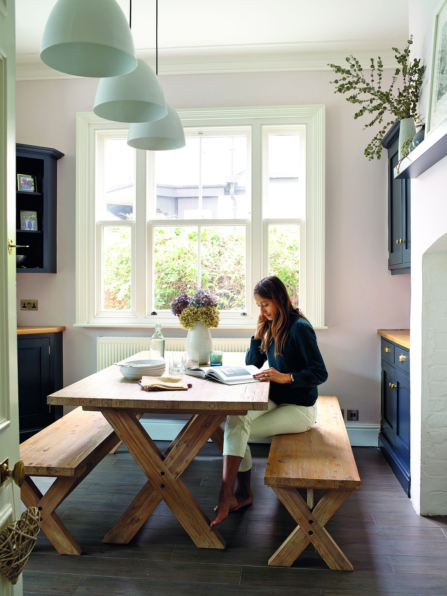 The Kettler Elba garden picnic dining table and chairs from John Lewis & Partners add a farmhouse feel to the kitchen. The built-in cabinetry was made by local firm Steve Hills Design and has been painted in Farrow & Ball Railings The Kettler Elba garden picnic dining table and chairs from John Lewis & Partners add a farmhouse feel to the kitchen. The built-in cabinetry was made by local firm Steve Hills Design and has been painted in Farrow & Ball Railings
