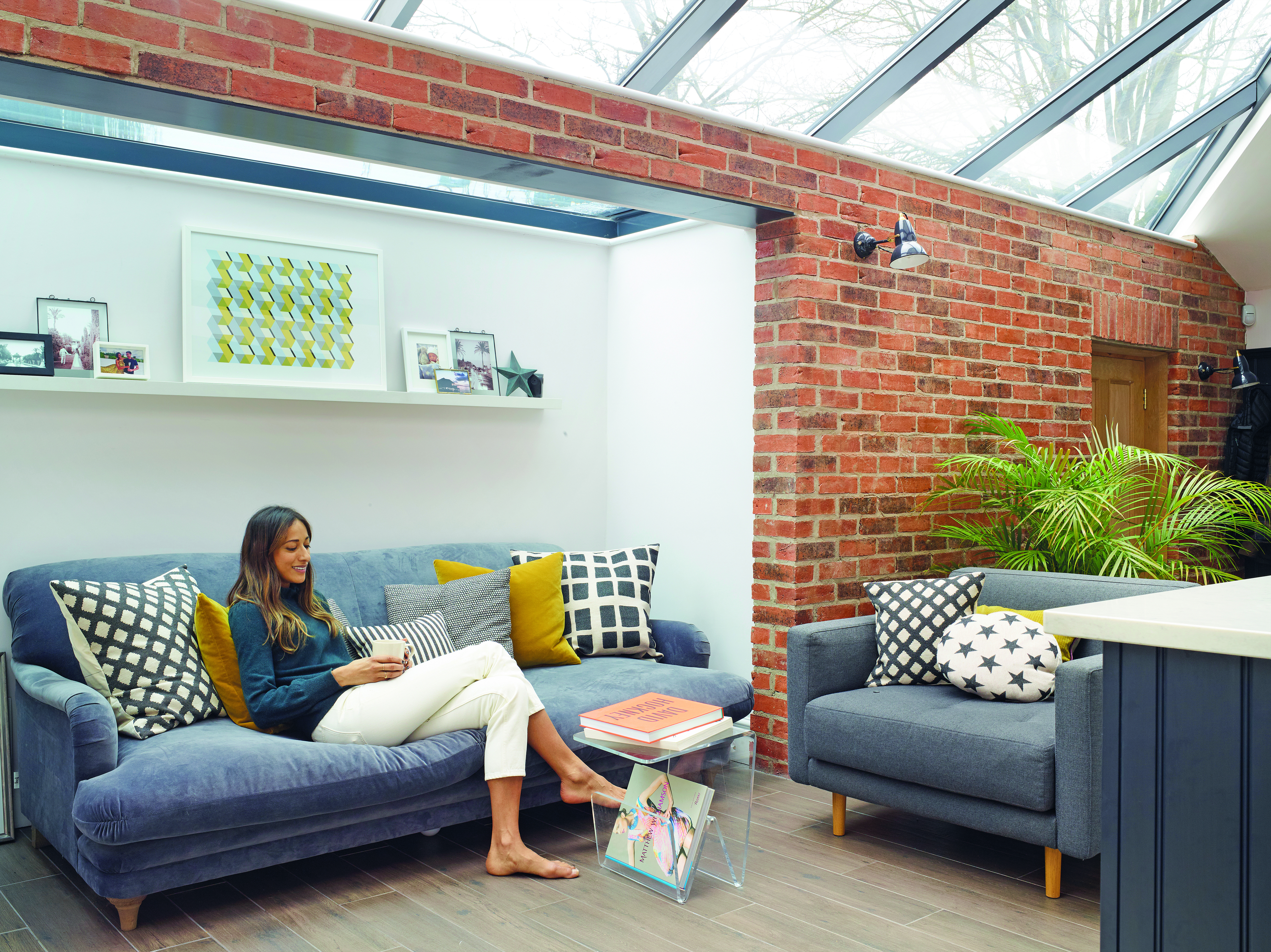 Positioned just off the kitchen, the Pudding sofa in Selvedge Blue from Loaf provides a cosy spot to sit. Artwork by local design company, Lane by Post, and a selection of cushions from H&M Home, Zara Home and Tori Murphy make the spot feel instantly homely Positioned just off the kitchen, the Pudding sofa in Selvedge Blue from Loaf provides a cosy spot to sit. Artwork by local design company, Lane by Post, and a selection of cushions from H&M Home, Zara Home and Tori Murphy make the spot feel instantly homely