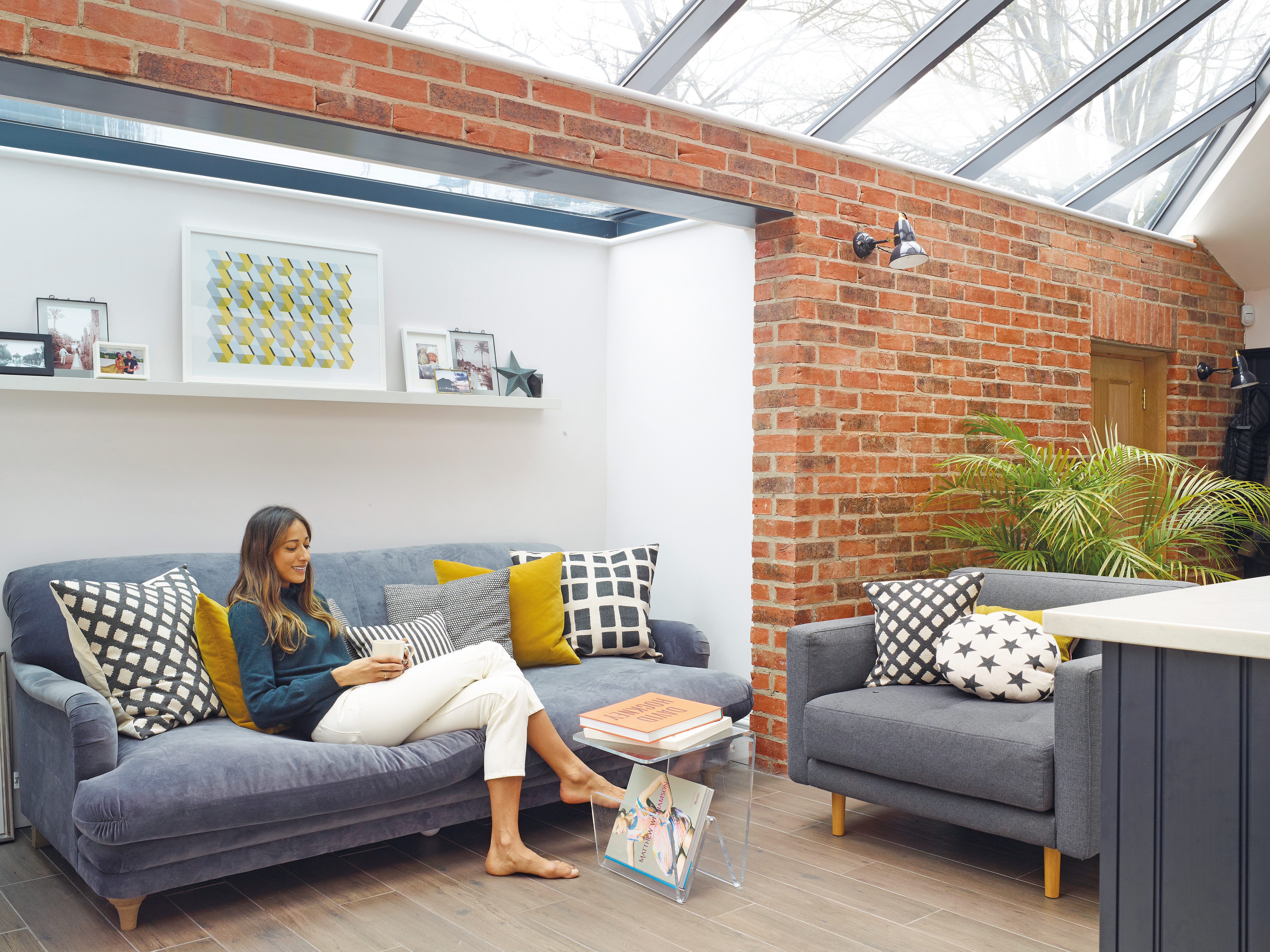 Positioned just off the kitchen, the Pudding sofa in Selvedge Blue from Loaf provides a cosy spot to sit. Artwork by local design company, Lane by Post, and a selection of cushions from H&M Home, Zara Home and Tori Murphy make the spot feel instantly homely Positioned just off the kitchen, the Pudding sofa in Selvedge Blue from Loaf provides a cosy spot to sit. Artwork by local design company, Lane by Post, and a selection of cushions from H&M Home, Zara Home and Tori Murphy make the spot feel instantly homely