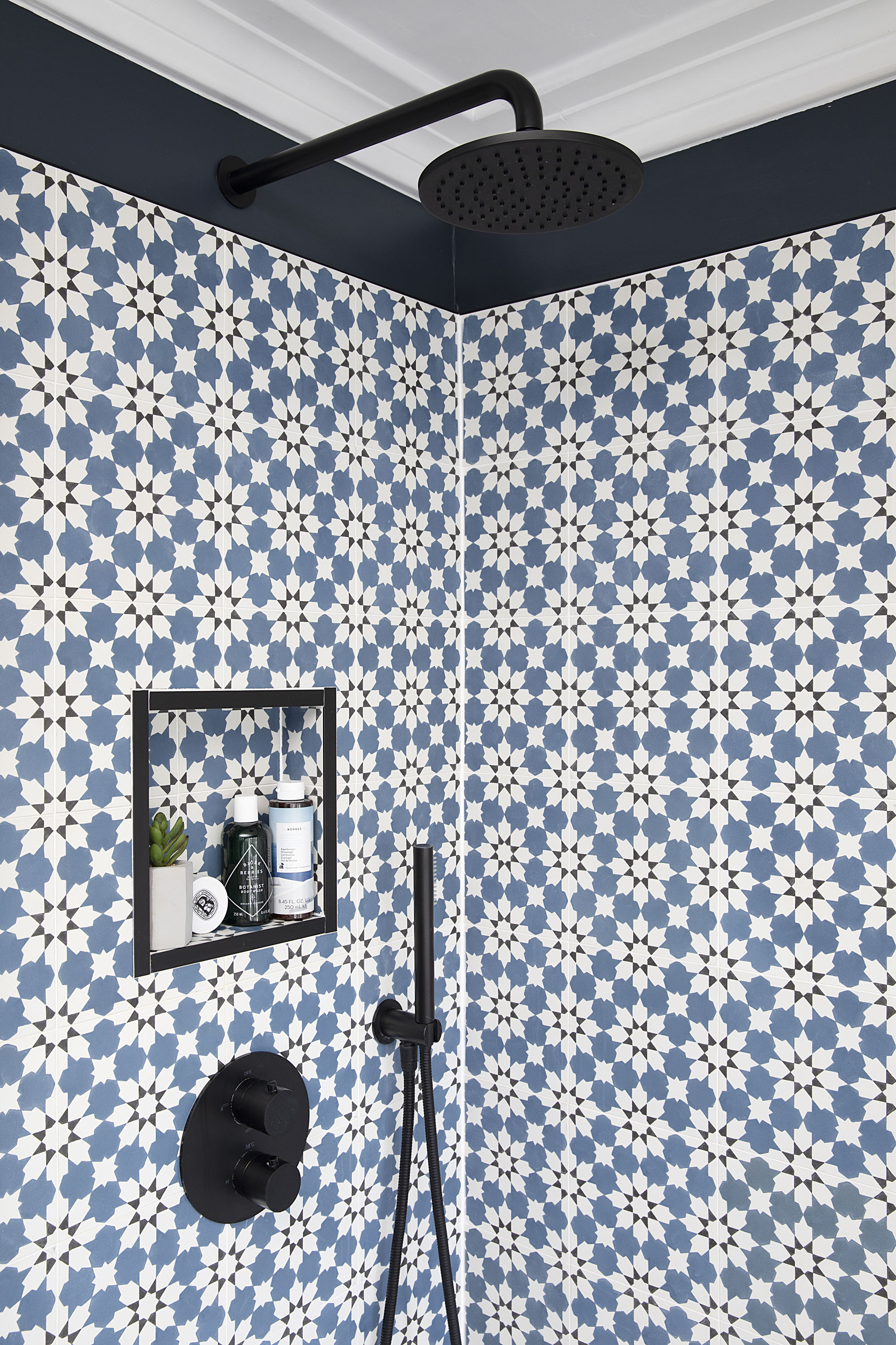 Claire chose hardware with curved edges for a polished look, including a round shower head and lever in a matt black finish, just like the Ibiza hotel bathroom that inspired her scheme