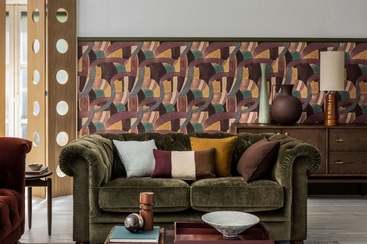 Velvet sofa with cushions and assortment of lamps