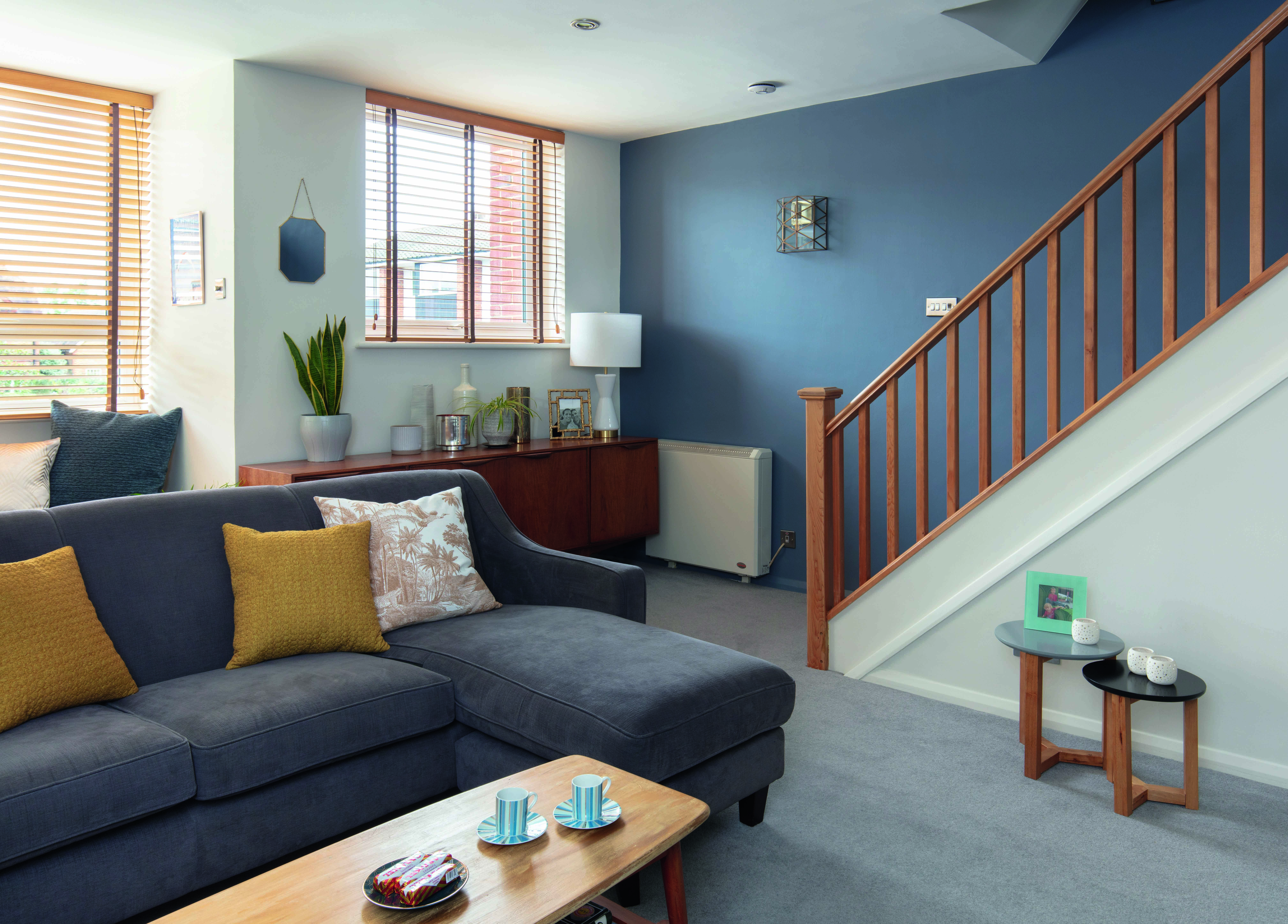 The wood tones of the sideboard and bannister bring warmth and contrast to Lynn’s smoky blue wall The wood tones of the sideboard and bannister bring warmth and contrast to Lynn’s smoky blue wall