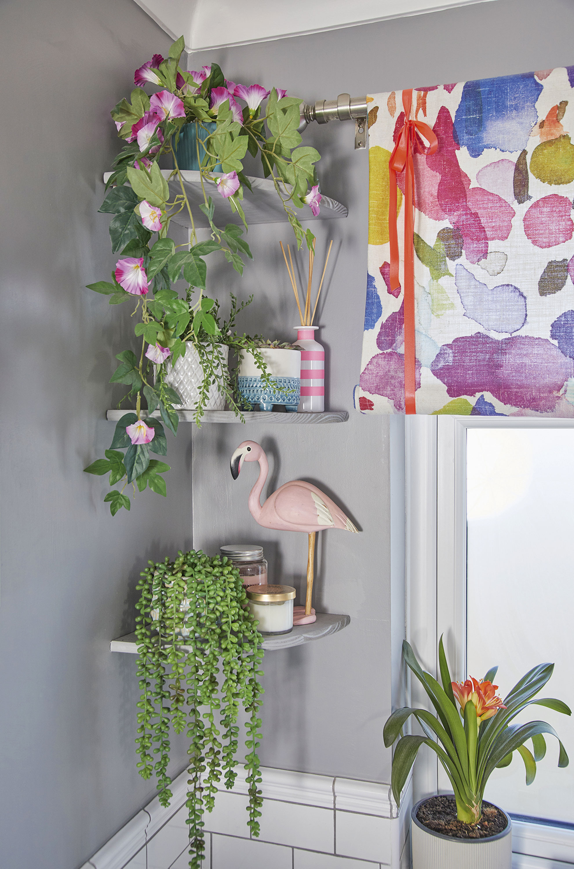 Bathroom makeover: 'My yellow bath makes me smile' ‘We decided the bathroom was a bit bare so added these cheap corner shelves to house some plants. We painted them the same colour as the walls to give them a modern edge’