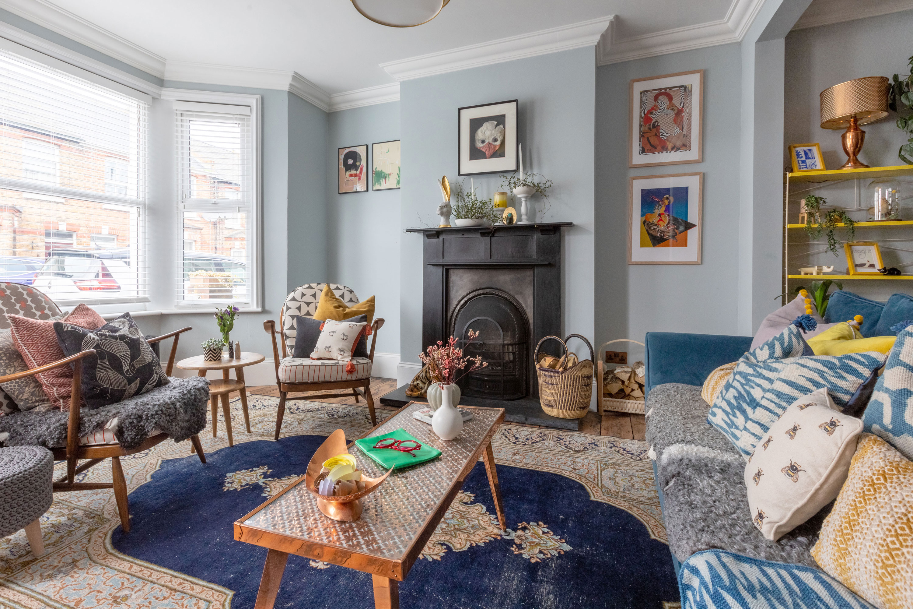 'Renovating gave us a blank canvas for our colourful, creative home' Make the most of a bright bay window with minimal white blinds to allow lots of natural light in. Carey also added interest by mixing different textiles on the mid-century chairs