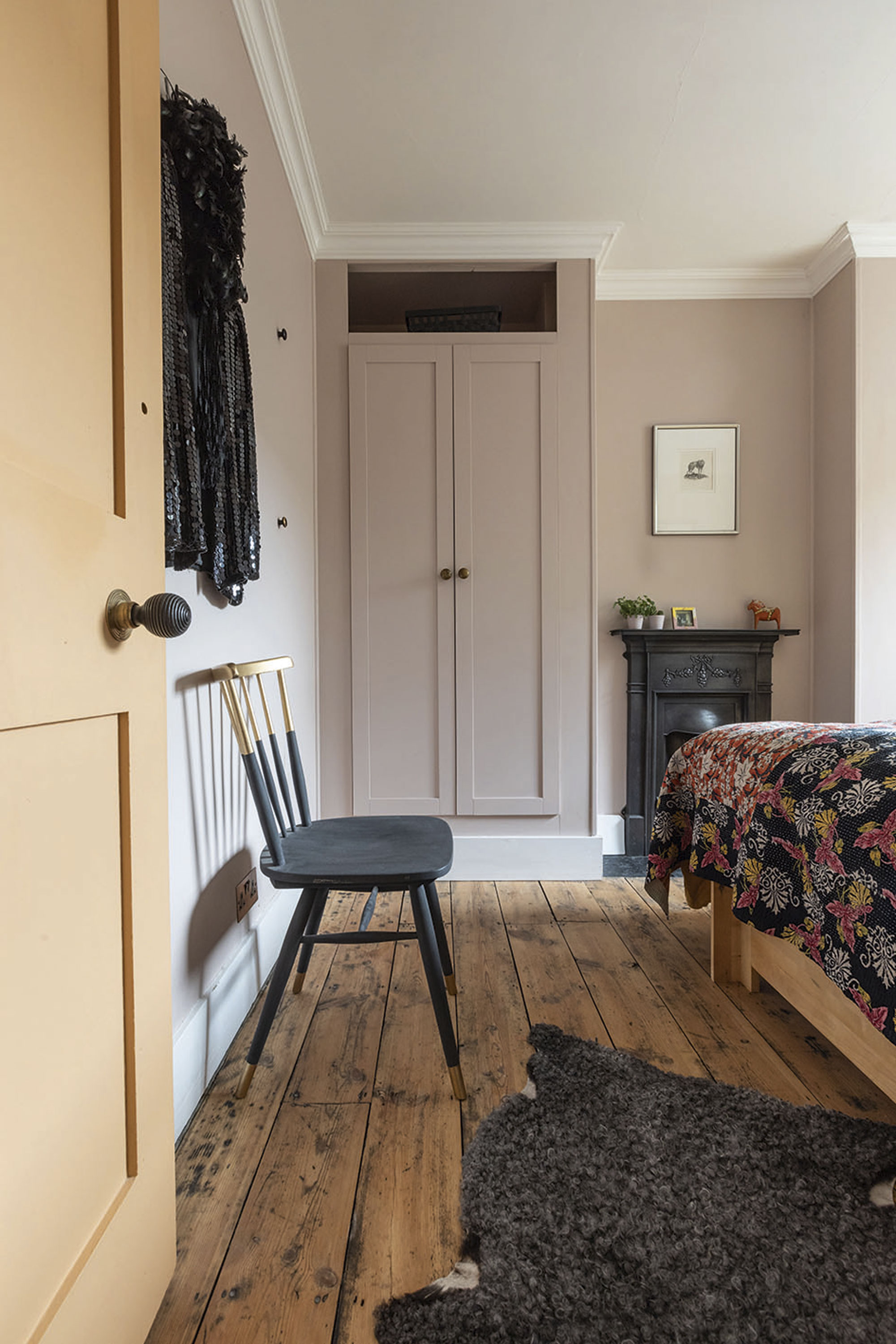 'Renovating gave us a blank canvas for our colourful, creative home' In the guest room, a colour scheme of mauve, black and grey draws the eye to the Victorian, cast iron fireplace. Carey and Johan designed the wardrobes themselves using IKEA doors, as in the main bedroom