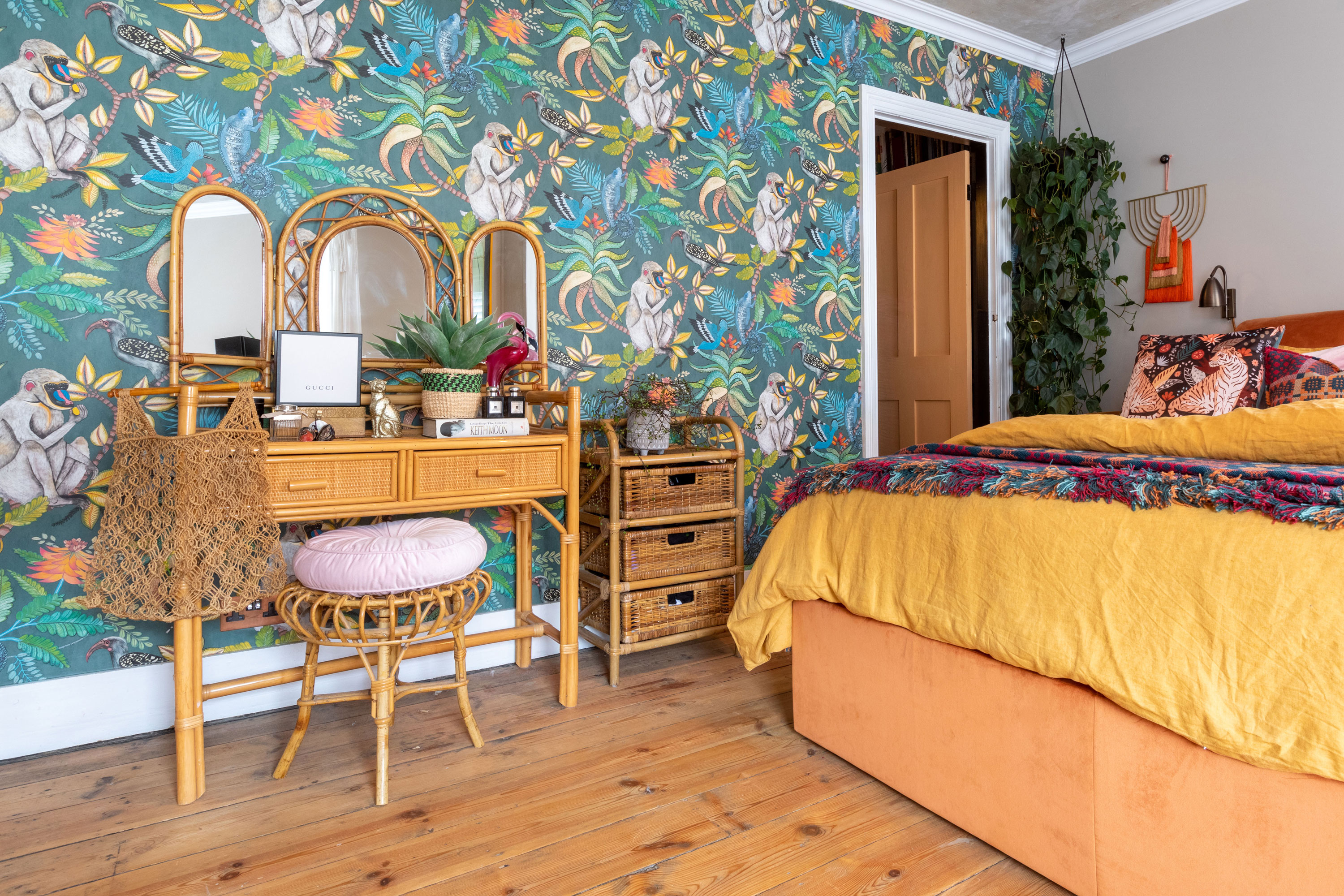 'Renovating gave us a blank canvas for our colourful, creative home' The colour continues upstairs in the main bedroom, with striking Serengeti wallpaper by Cole & Sons providing the reference for a mix of jungle-inspired textiles and ornaments. A concrete-effect ceiling adds further interest and texture to create a snug, eclectic space