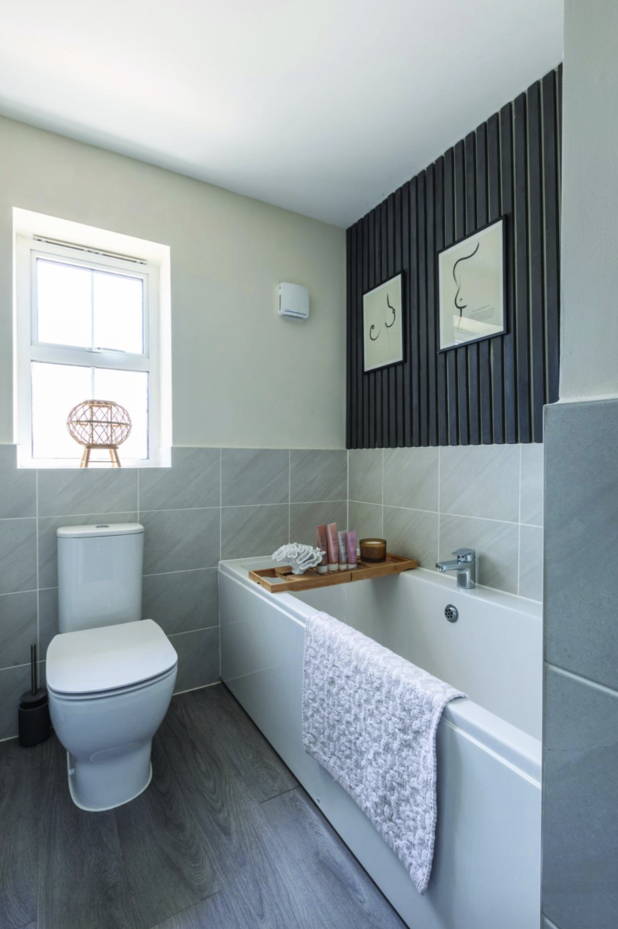 Yooni elevated her simple bathroom with a panelled wall, created from wooden slats painted with Rust- Oleum furniture paint in Graphite Yooni elevated her simple bathroom with a panelled wall, created from wooden slats painted with Rust- Oleum furniture paint in Graphite