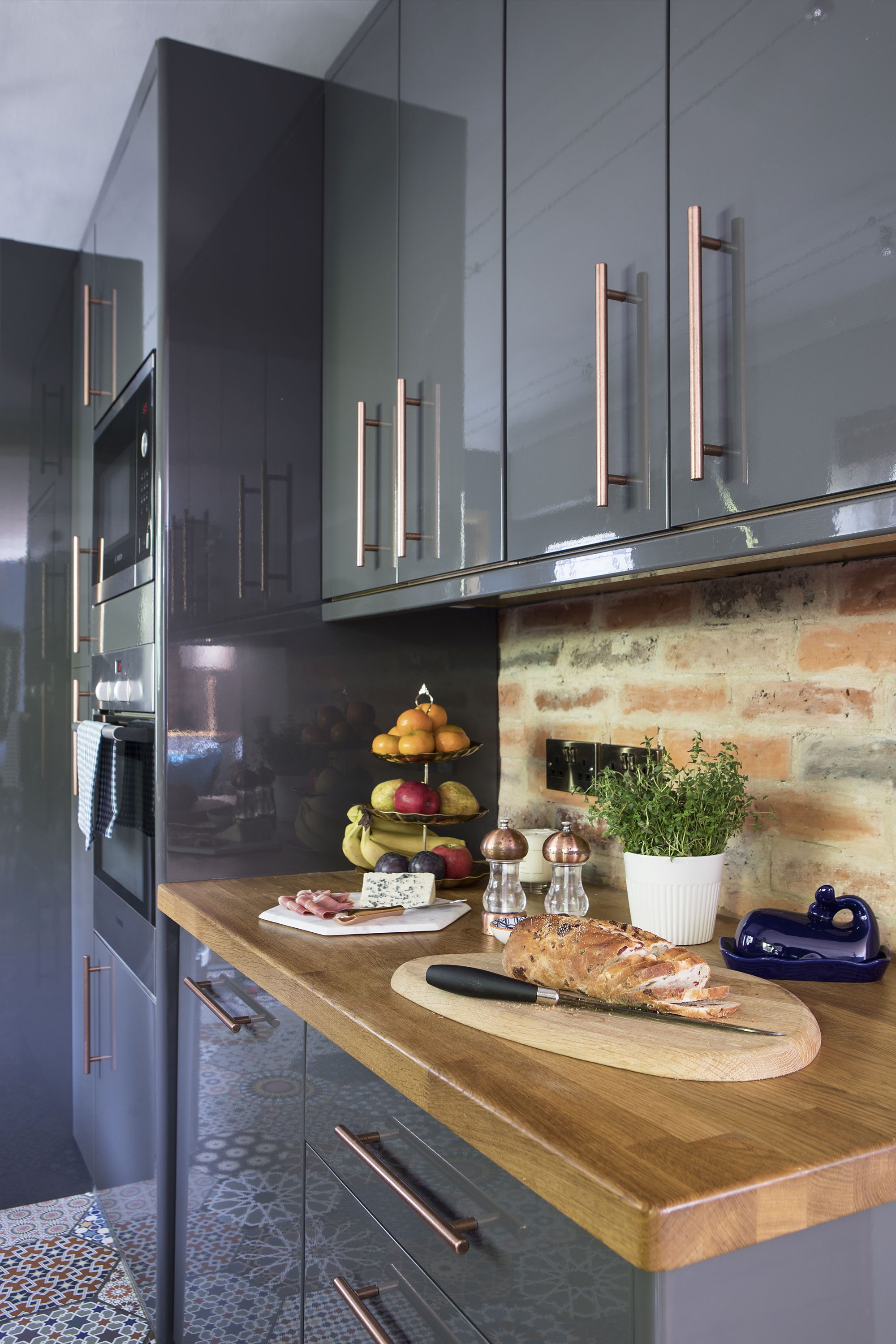 Finding the bare bones of the original brick wall to be too white, Dace created a splashback with brick slips in tonal oranges and greys to match with the floor and worktop Finding the bare bones of the original brick wall to be too white, Dace created a splashback with brick slips in tonal oranges and greys to match with the floor and worktop