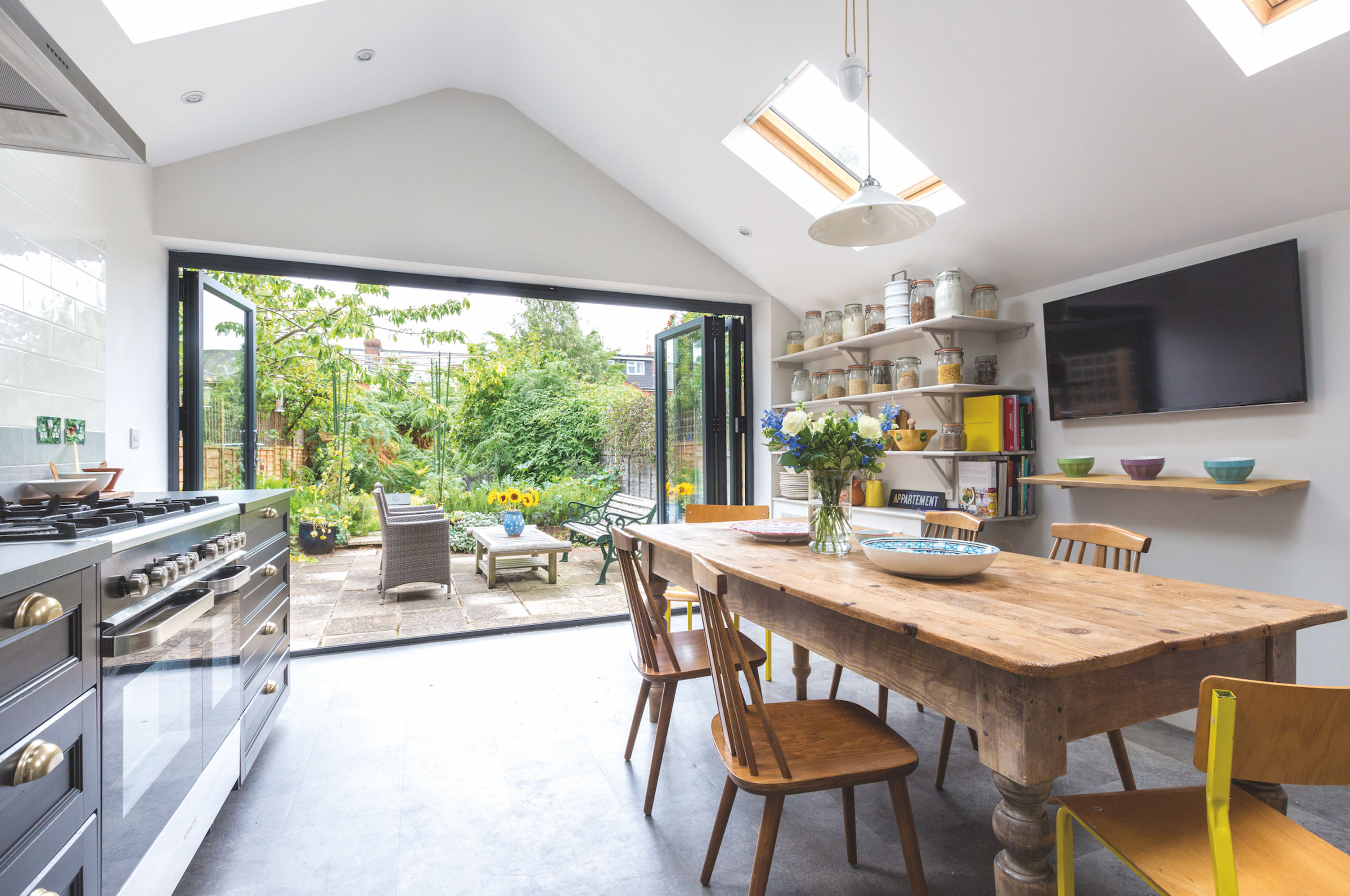 With a bright living space in mind, Lily planned the entire extension around having a generous kitchen table and bifold doors to bring the outside in Kitchen makeover - bifold doors in the kitchen looking out onto a garden