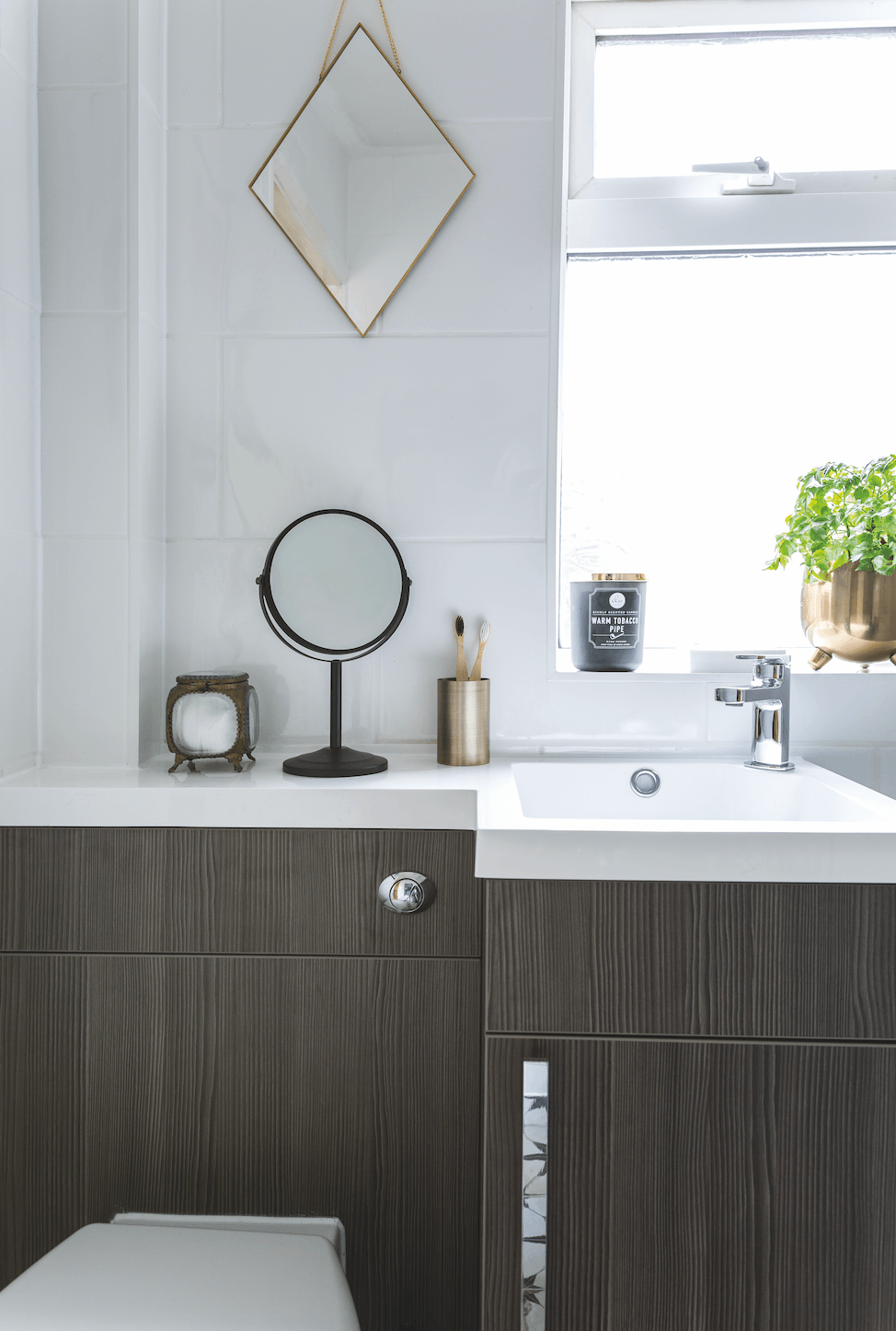 Built-in countertops make use of the top of the toilet, creating an extra surface for storing essentials Bathroom makeover: 'Our bathroom feels like a mini boutique hotel'