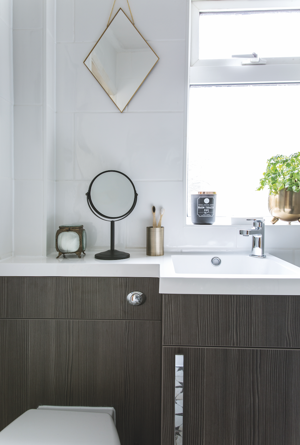 Built-in countertops make use of the top of the toilet, creating an extra surface for storing essentials Bathroom makeover: 'Our bathroom feels like a mini boutique hotel'