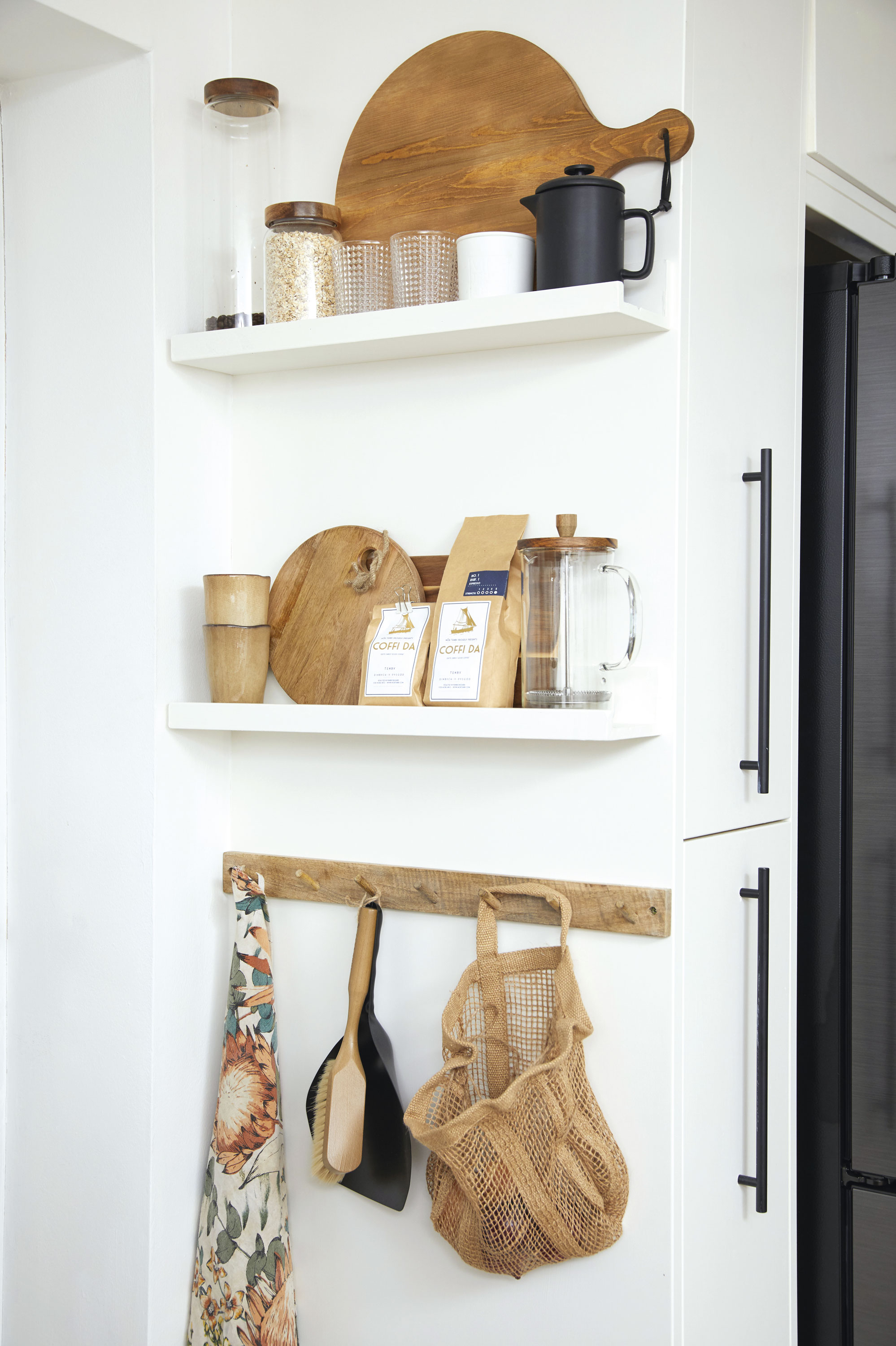 'DIY hacks have saved us a fortune' ‘I made this pantry corner out of IKEA picture ledges painted the same colour as the cabinets. I added the wooden hooks, from H&M Home, to create a display and add colour and texture to the space’