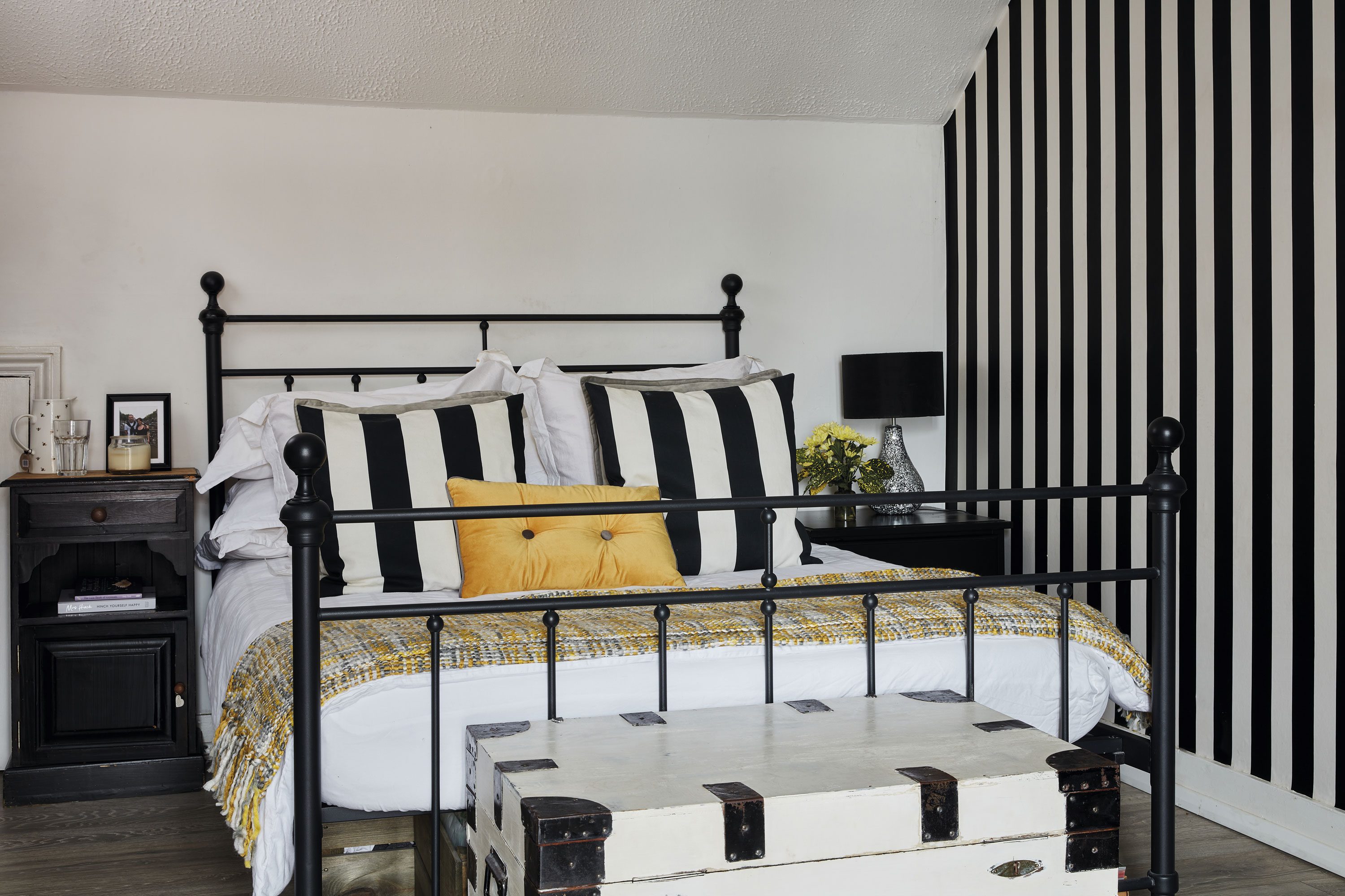 Sharon’s daughter, India choose the décor of the attic bedroom picking out a monochrome striped wallpaper from Wilko for the walls and matching cushions from IKEA. ‘The wooden storage box has been with us from house to house,’ says Sharon. ‘Originally, it was dark wood, but I painted it white to match India’s room design’ Sharon’s daughter, India choose the décor of the attic bedroom picking out a monochrome striped wallpaper from Wilko for the walls and matching cushions from IKEA. ‘The wooden storage box has been with us from house to house,’ says Sharon. ‘Originally, it was dark wood, but I painted it white to match India’s room design’