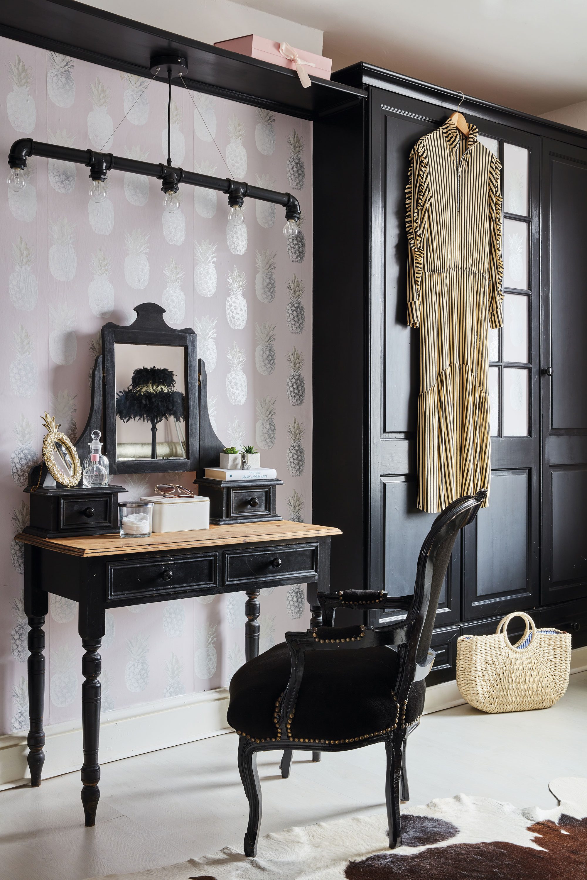 Behind the dressing table, Sharon has put up a metallic pineapple wallpaper from B&Q. ‘We all store our clothes in here and it’s a lovely space to get ready in,’ she says. The black chair was a birthday gift from David to Sharon. Above the upcycled dressing table hangs an industrial light fitting found on eBay Behind the dressing table, Sharon has put up a metallic pineapple wallpaper from B&Q. ‘We all store our clothes in here and it’s a lovely space to get ready in,’ she says. The black chair was a birthday gift from David to Sharon. Above the upcycled dressing table hangs an industrial light fitting found on eBay