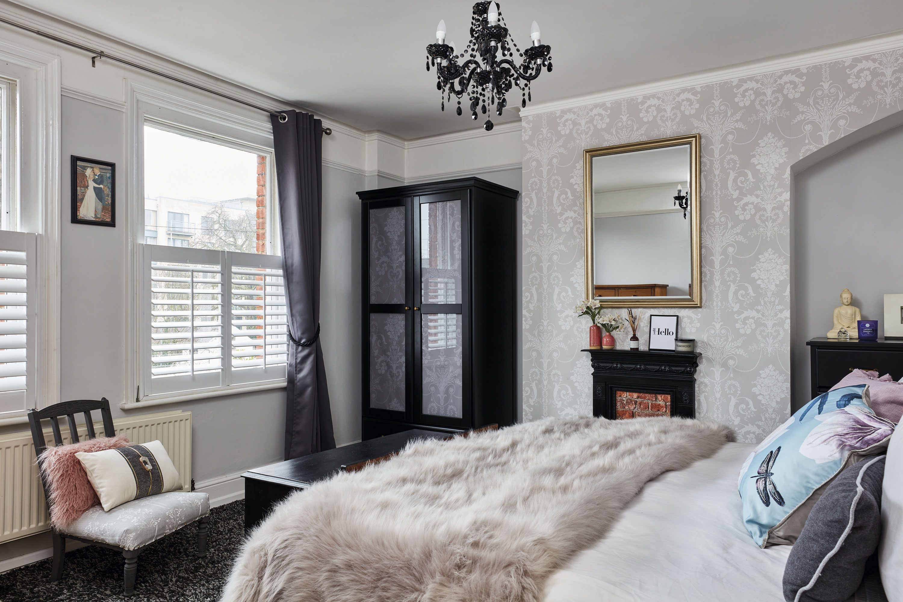 ‘We salvaged an ironwork fireplace for our master bedroom. Behind the surround, we cheated a brick effect with wallpaper’ ‘We salvaged an ironwork fireplace for our master bedroom. Behind the surround, we cheated a brick effect with wallpaper’