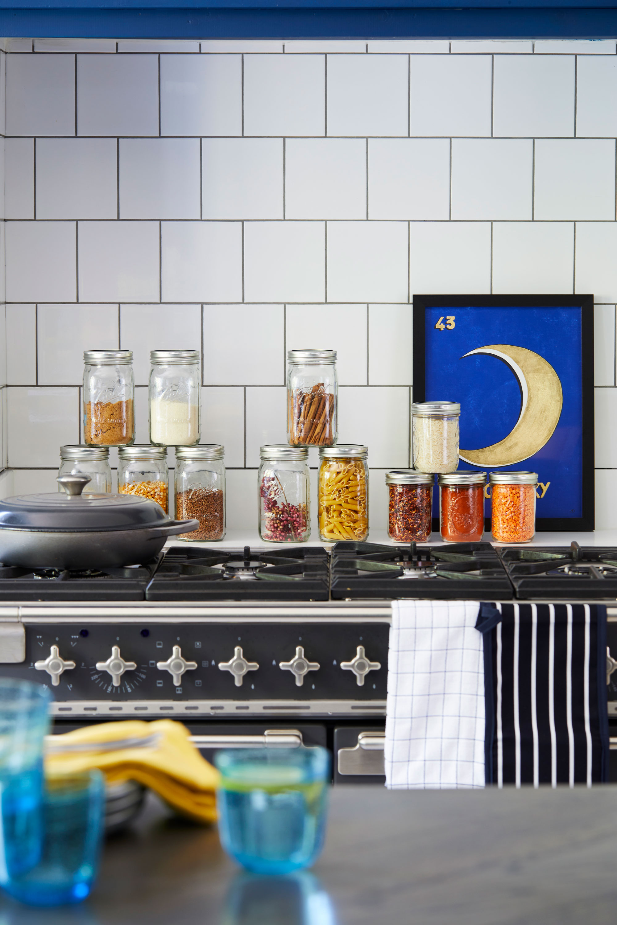 Blue-Kitchen_016 Good idea! Rather than block up a redundant chimney breast, the couple used the extra depth behind the cooker to create a handy storage area for everyday culinary essentials
