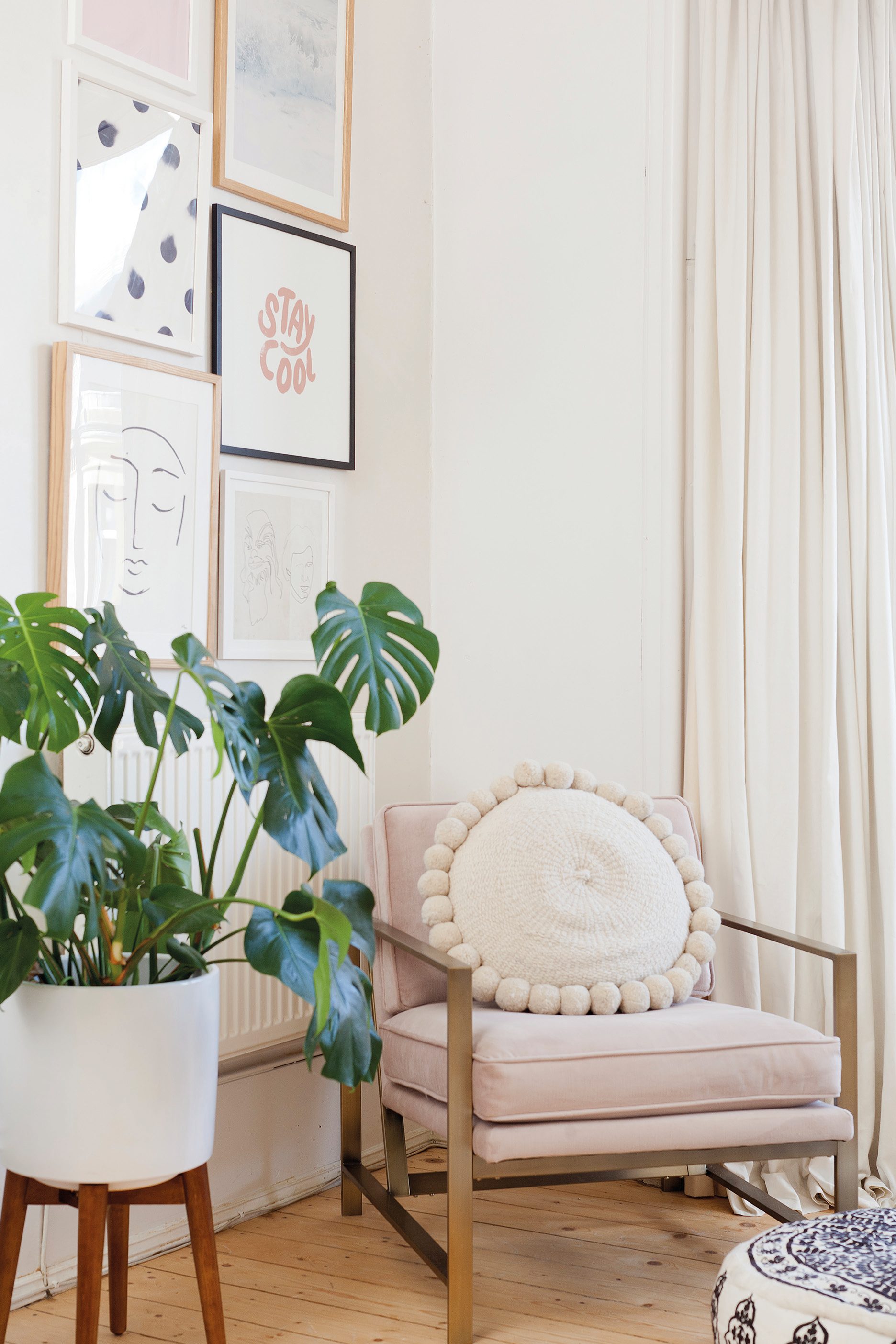 Home makeover: 'Our flat has bags of character!' Kate has broken up the white walls with a gallery display of prints from Oliver Bonas, Etsy and Society6. The corner is also a reading nook with a metal frame chair from West Elm