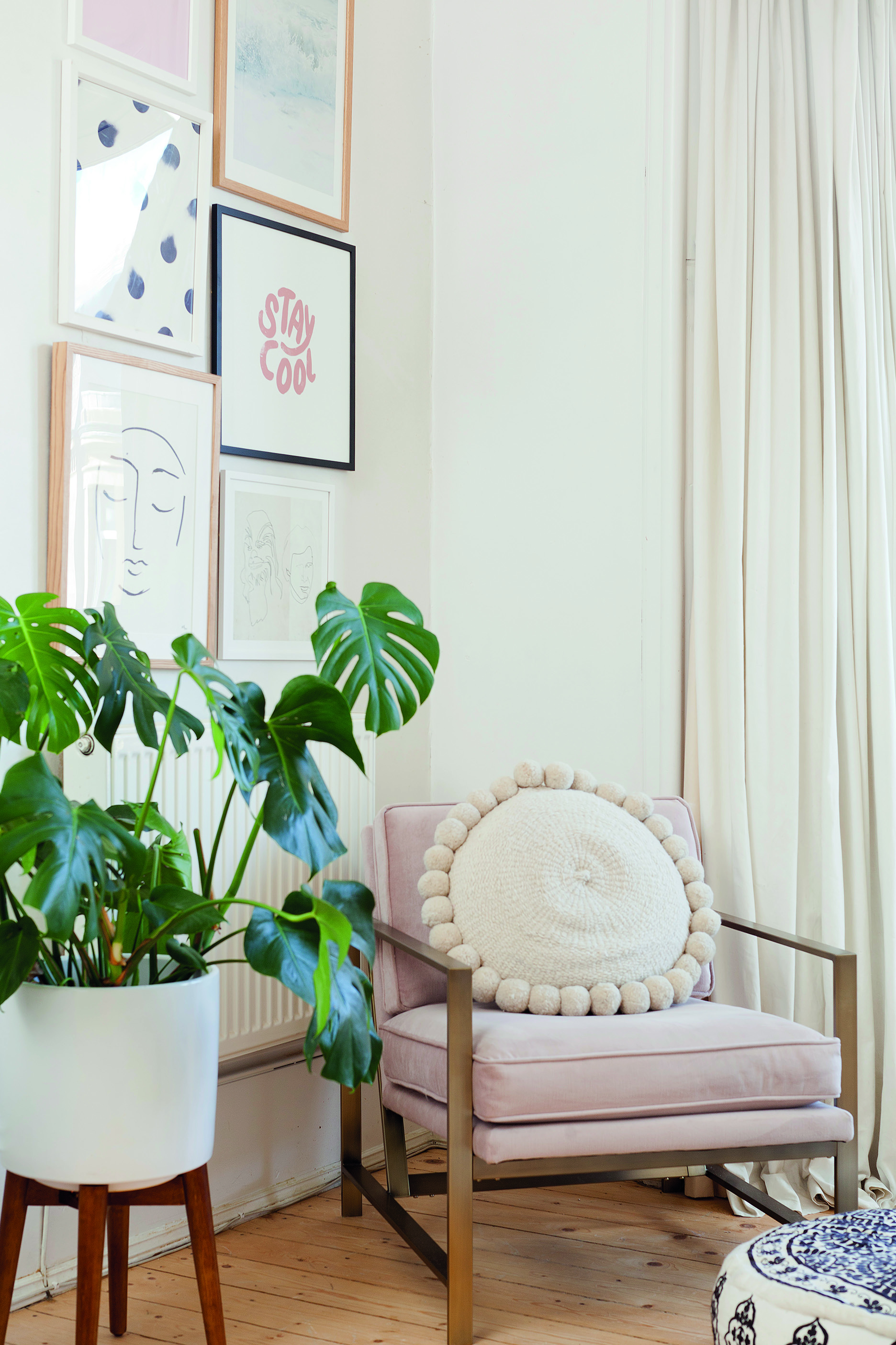 Home makeover: 'Our flat has bags of character!' Kate has broken up the white walls with a gallery display of prints from Oliver Bonas, Etsy and Society6. The corner is also a reading nook with a metal frame chair from West Elm