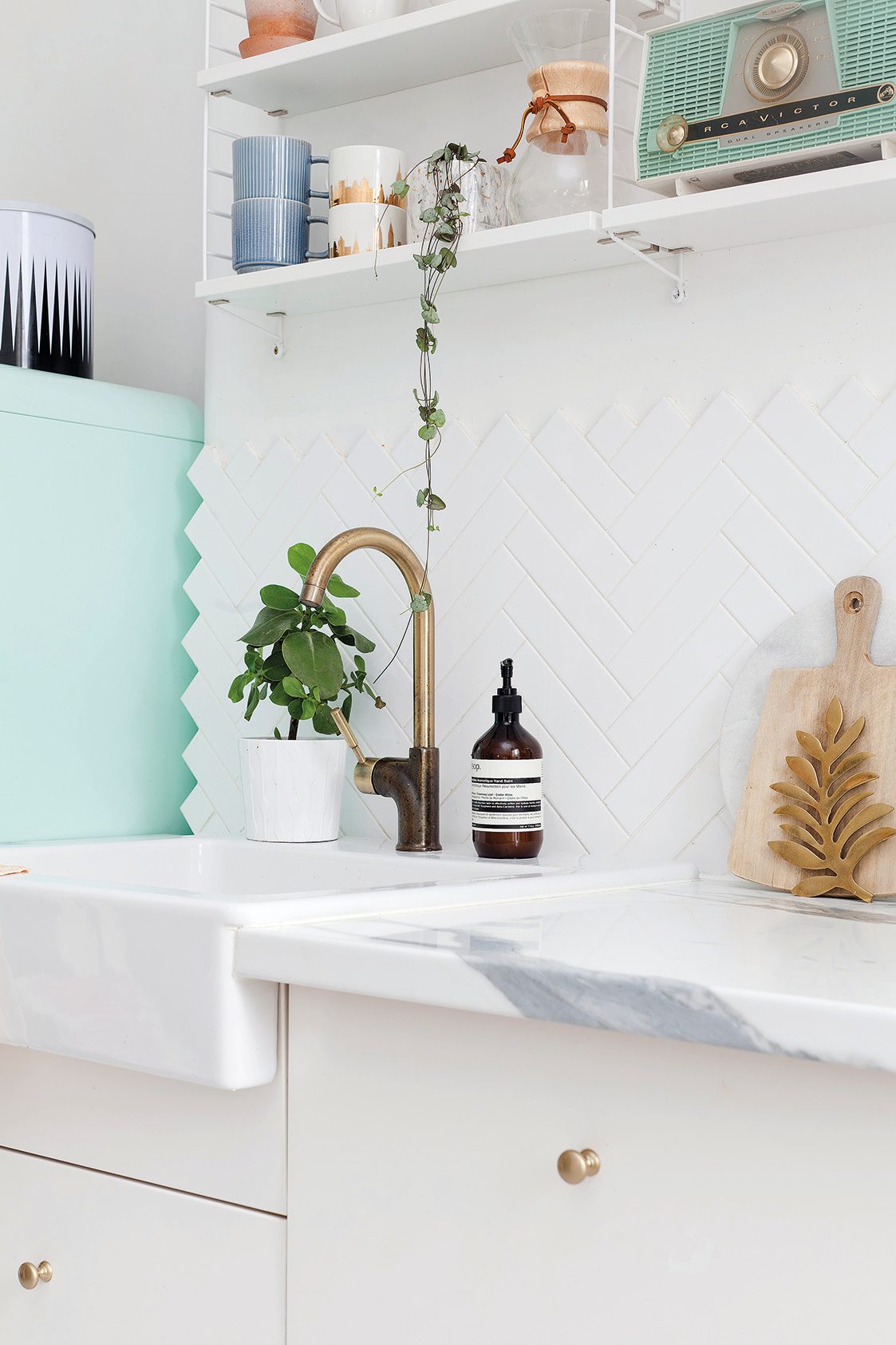 Home makeover: 'Our flat has bags of character!' A copper tap over the Belfast sink ties in perfectly with all of the other metallic