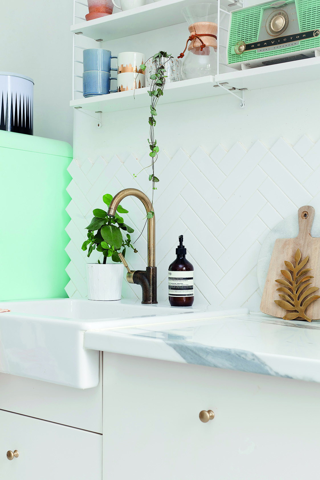 Home makeover: 'Our flat has bags of character!' A copper tap over the Belfast sink ties in perfectly with all of the other metallic