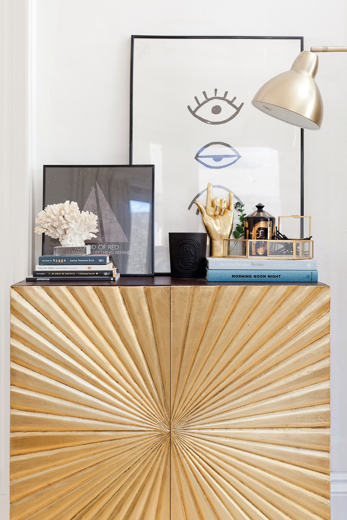Home makeover: 'Our flat has bags of character!' This striking gold and black sideboard from Swoon Editions gives the living room an instant shot of glam. Kate has styled it up with artwork from Society6, books and a collection of quirky accessories with gold and black accents to tie the look together