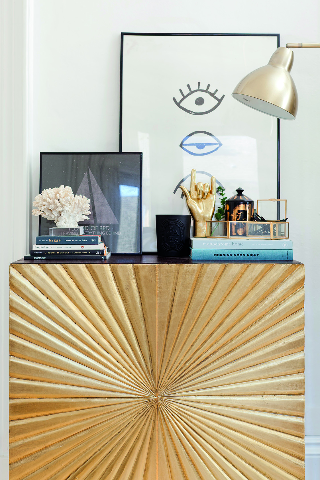 Home makeover: 'Our flat has bags of character!' This striking gold and black sideboard from Swoon Editions gives the living room an instant shot of glam. Kate has styled it up with artwork from Society6, books and a collection of quirky accessories with gold and black accents to tie the look together