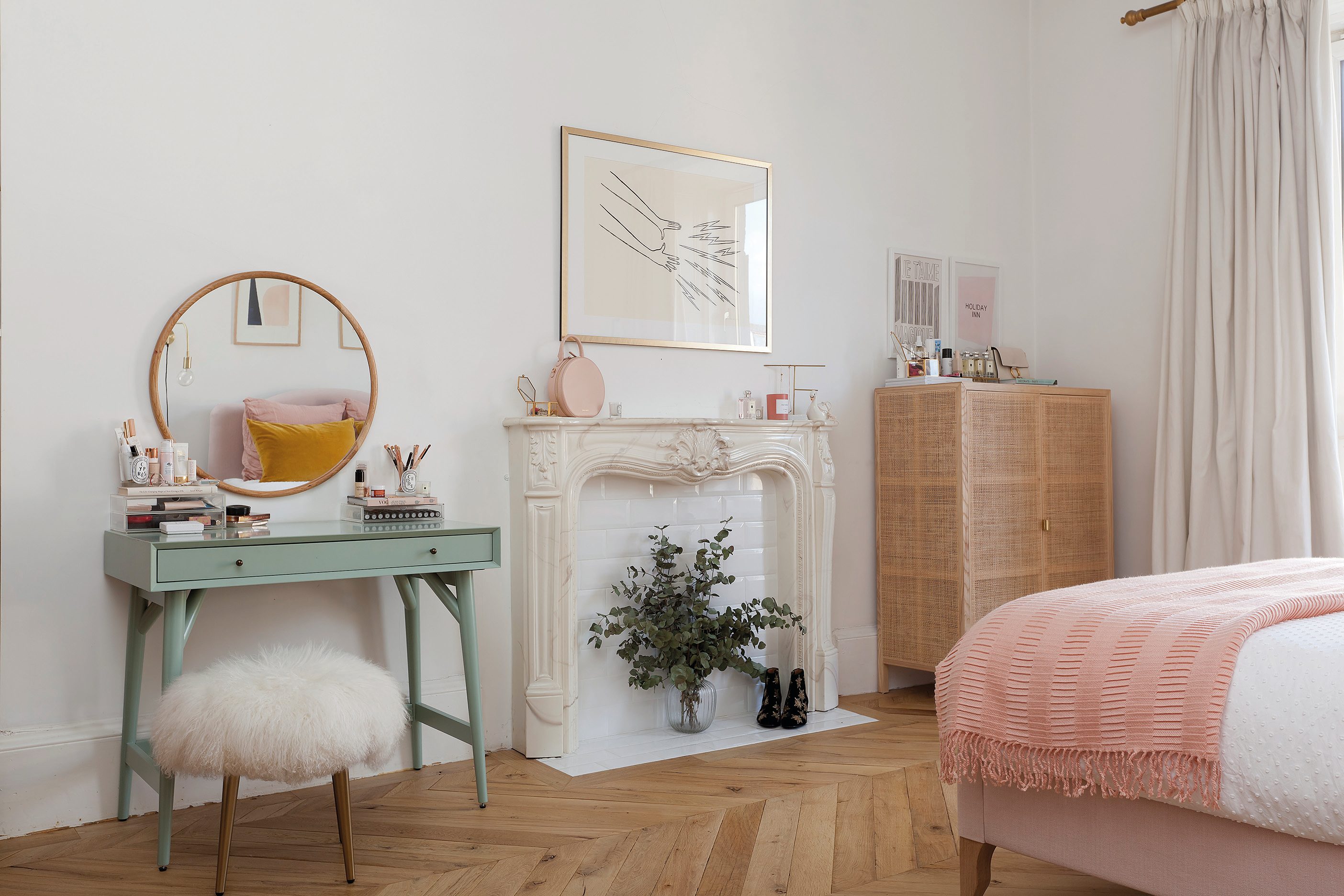 Home makeover: 'Our flat has bags of character!' Kate has made a feature of the fireplace with some dried foliage. The green desk – used as a dressing table – from West Elm adds a splash of colour