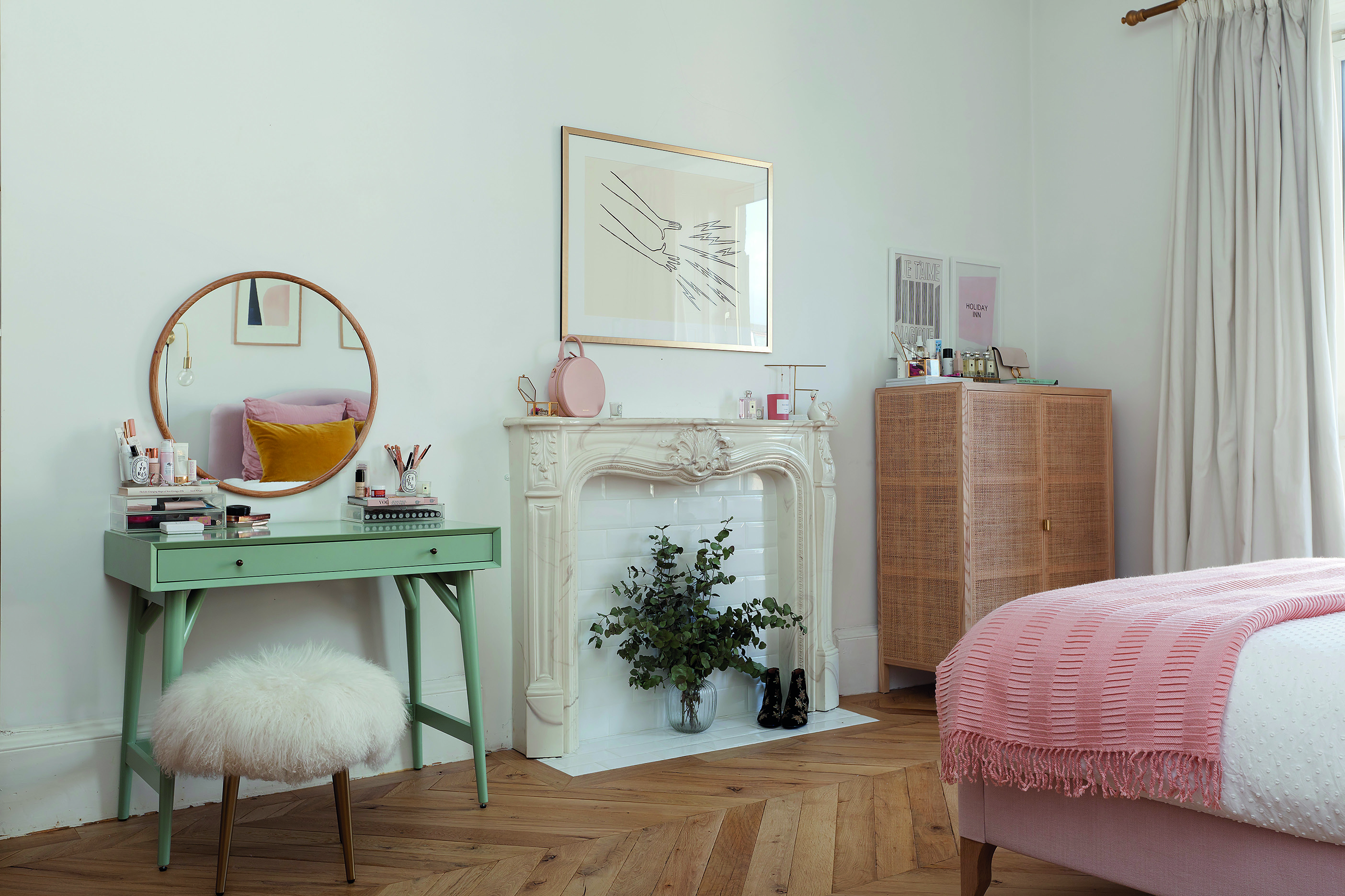 Home makeover: 'Our flat has bags of character!' Kate has made a feature of the fireplace with some dried foliage. The green desk – used as a dressing table – from West Elm adds a splash of colour