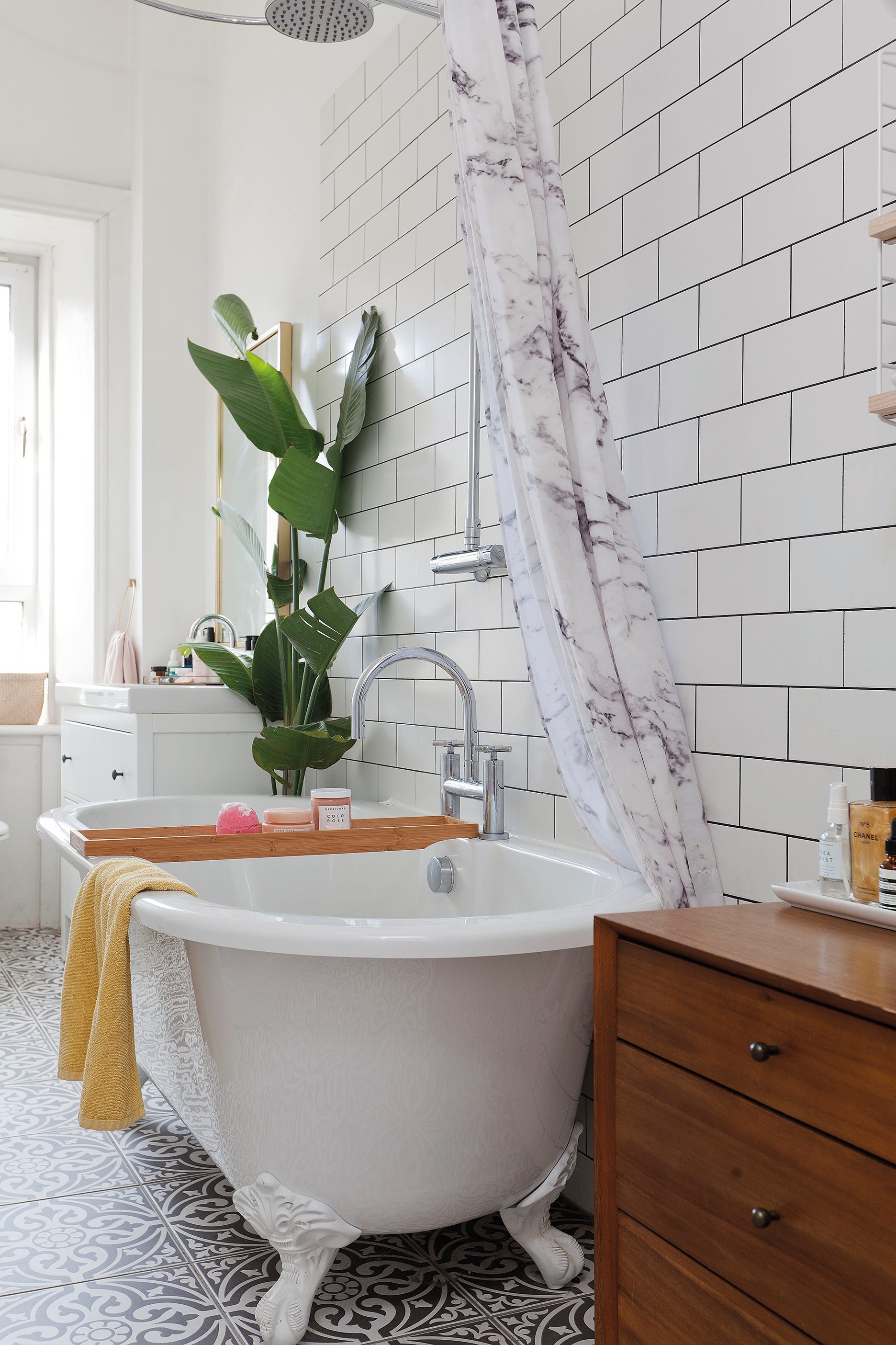 Home makeover: 'Our flat has bags of character!' Plenty of plants and fresh white tiles create a serene look in the bathroom. Wanting to steer away from built-in furniture, Kate has used baskets for storage, as well as a vintage-look dresser and chest of drawers