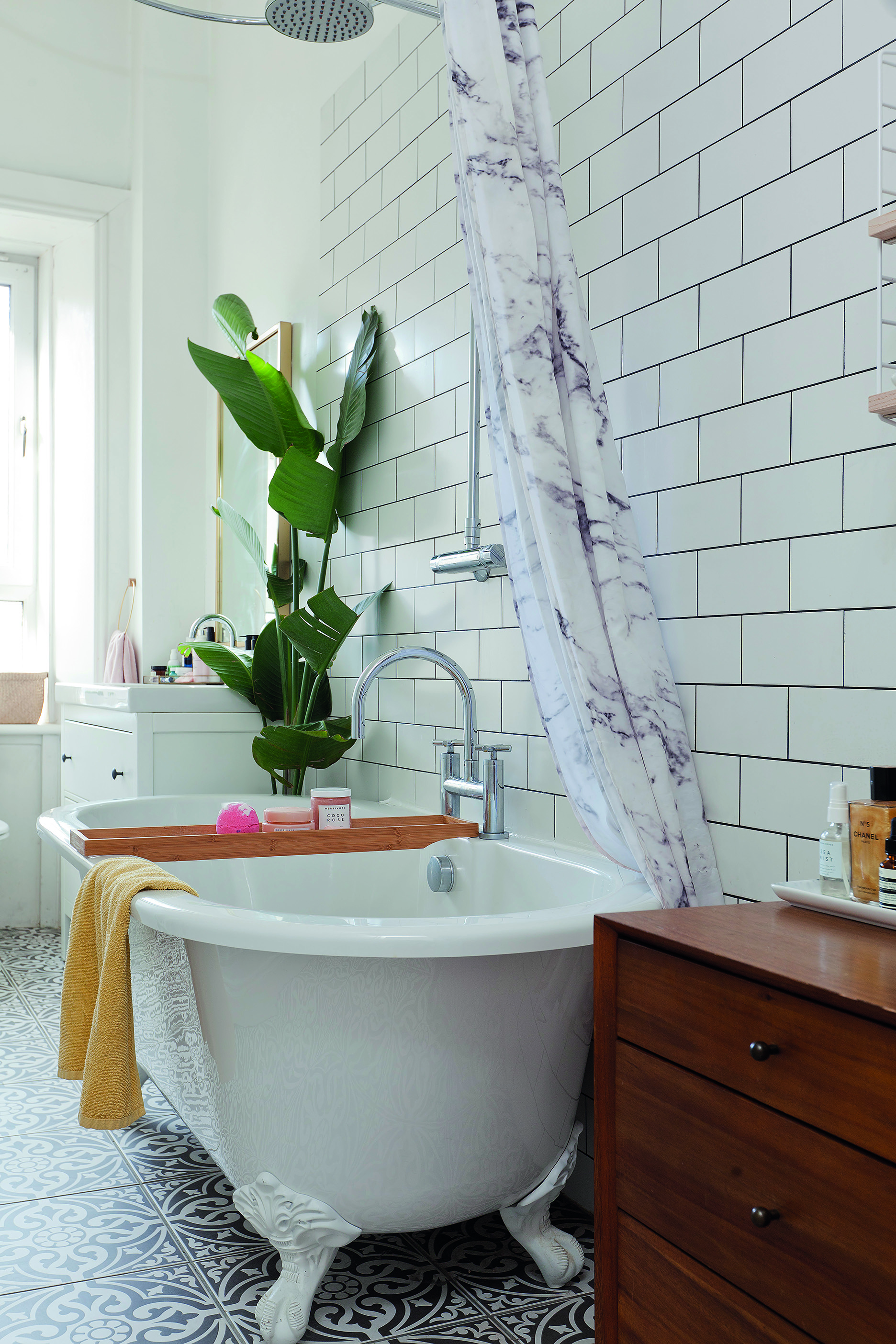 Home makeover: 'Our flat has bags of character!' Plenty of plants and fresh white tiles create a serene look in the bathroom. Wanting to steer away from built-in furniture, Kate has used baskets for storage, as well as a vintage-look dresser and chest of drawers