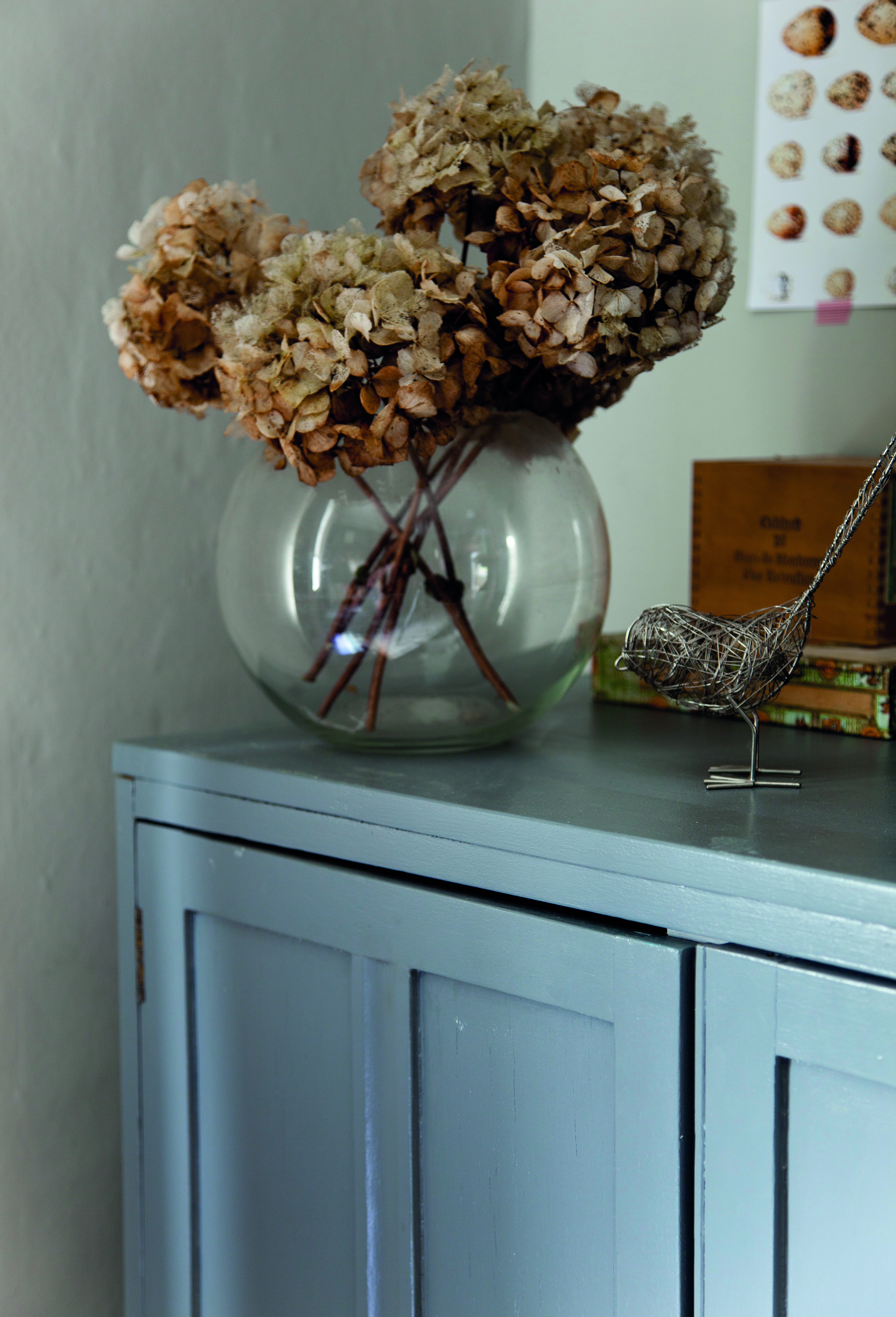 Christine gathered hydrangeas from her garden and dried them to create an everlasting floral display A round glass vase full of dried hydrangeas