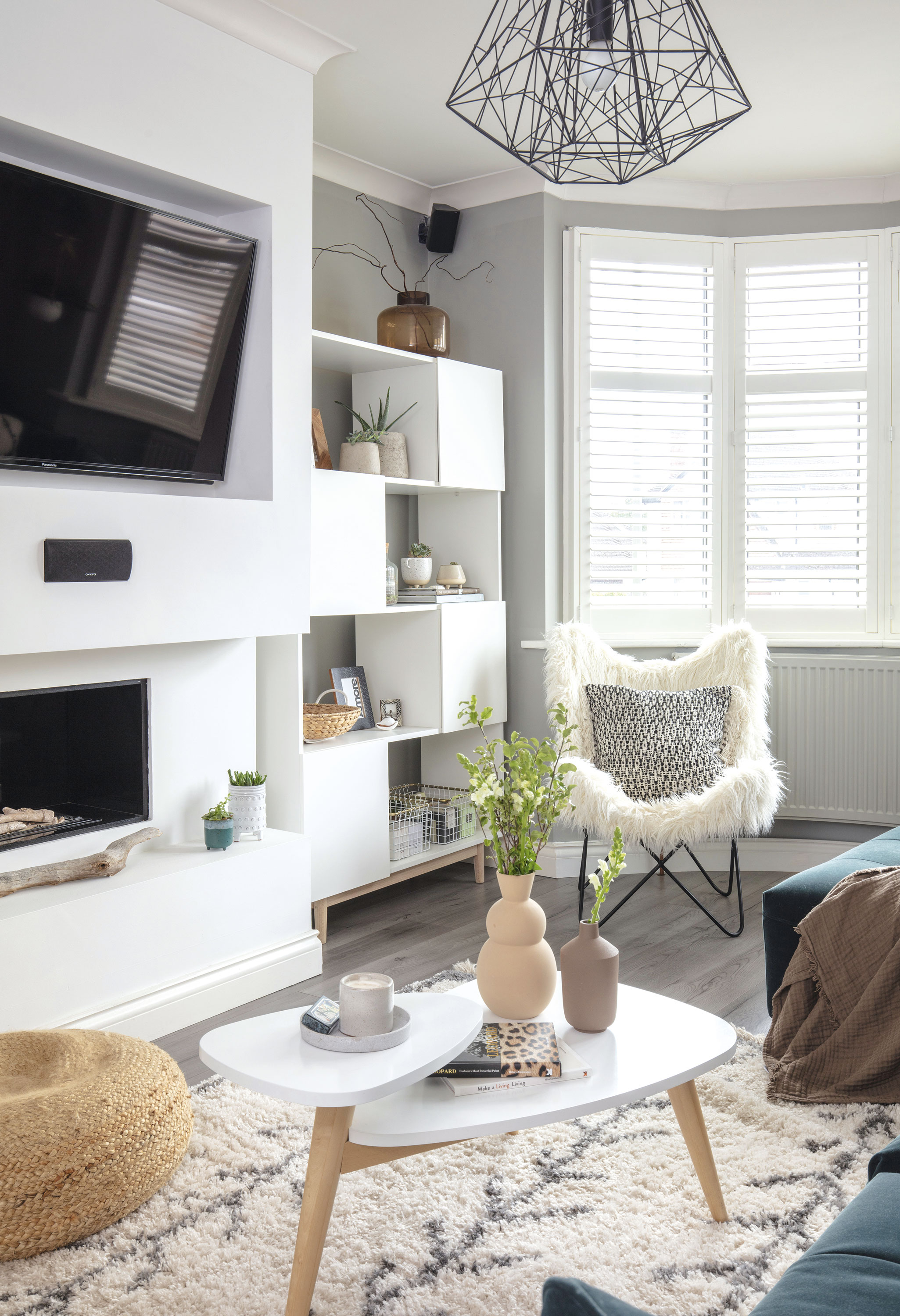 A large false wall houses the gas fire and TV. The log-effect ties in well with the nature-inspired accessories Yoko has used in the room, including a piece of driftwood she found on the beach A large false wall houses the gas fire and TV. The log-effect ties in well with the nature-inspired accessories Yoko has used in the room, including a piece of driftwood she found on the beach