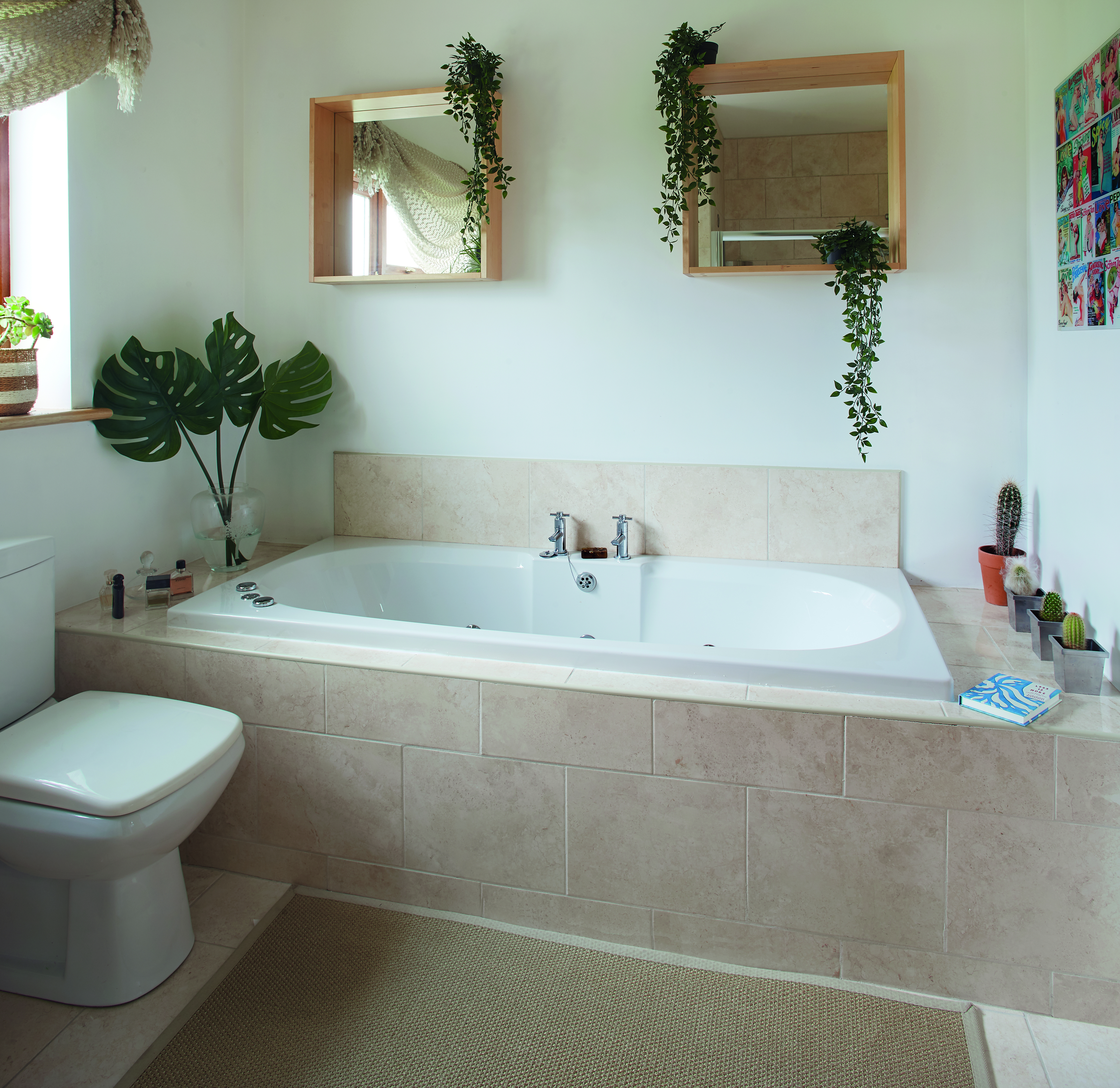 The basic bathroom is slated for refurbishment, but Elaine has cheered it up with mirrors and faux trailing plants from IKEA and an art print from TK Maxx. The faux cheese plant leaves are also from IKEA and the tiles are from Armatile The basic bathroom is slated for refurbishment, but Elaine has cheered it up with mirrors and faux trailing plants from IKEA and an art print from TK Maxx. The faux cheese plant leaves are also from IKEA and the tiles are from Armatile