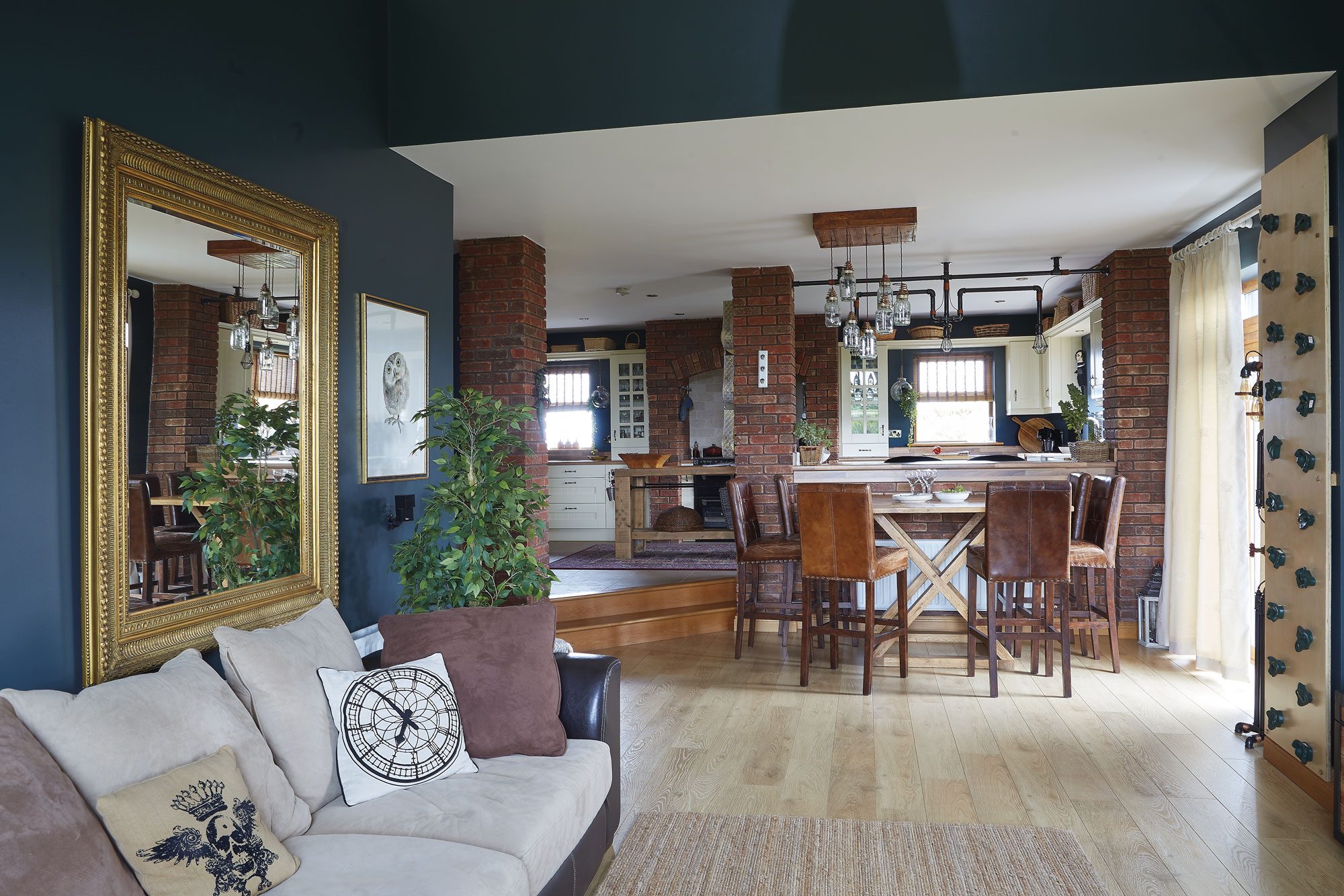 The couple wanted to connect the dining and kitchen areas, and put the dining table behind the breakfast bar. Shane made the industrial-look light fittings from plumbing supplies and salvaged timber. The dining table and chairs came from The 1933 Furniture Company in Navan