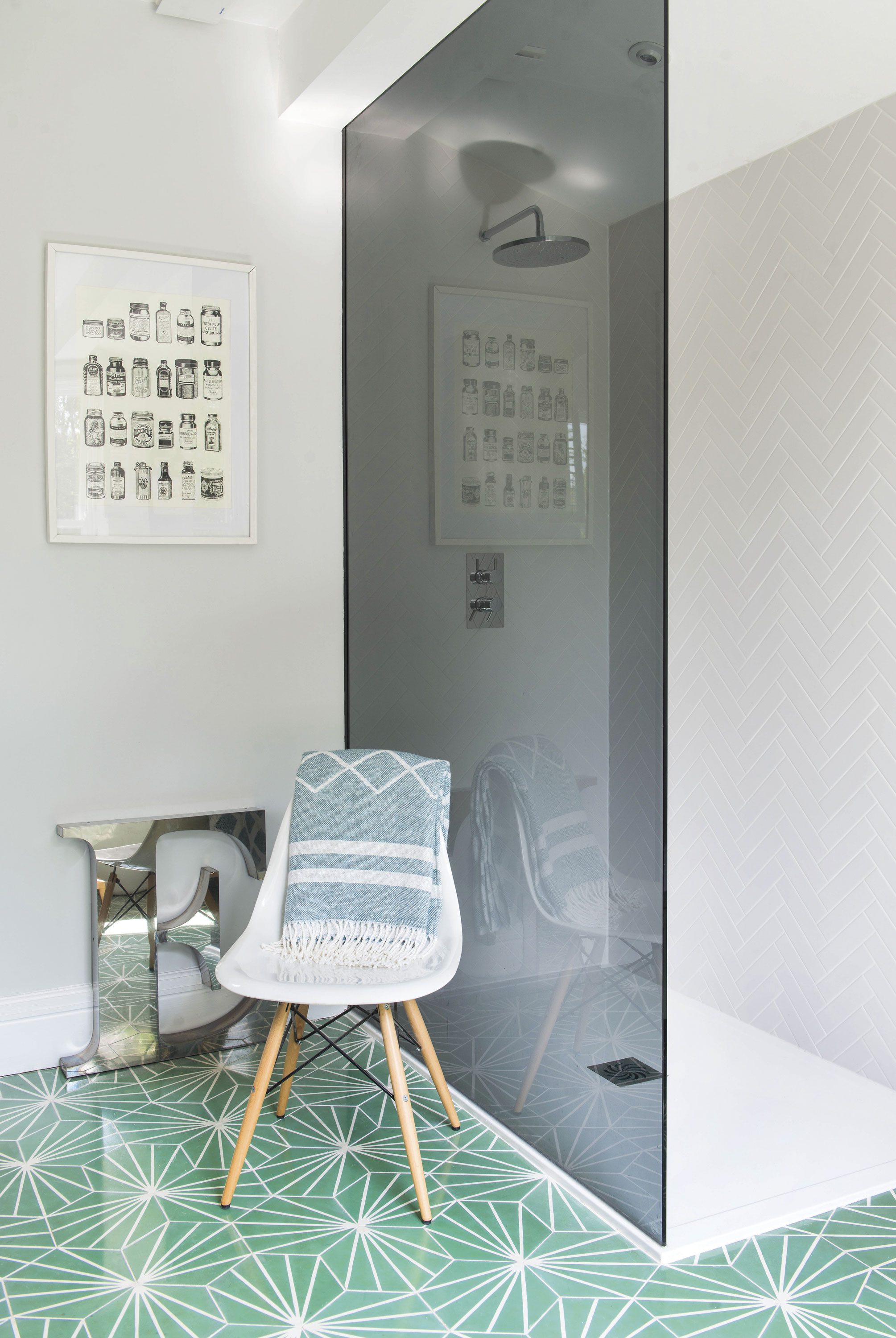 ‘I love the glass panel, which was specially fitted by Leeds Glass,’ says Sarah. The sleek look is completed with rectangular tiles laid in a herringbone pattern ‘I love the glass panel, which was specially fitted by Leeds Glass,’ says Sarah. The sleek look is completed with rectangular tiles laid in a herringbone pattern