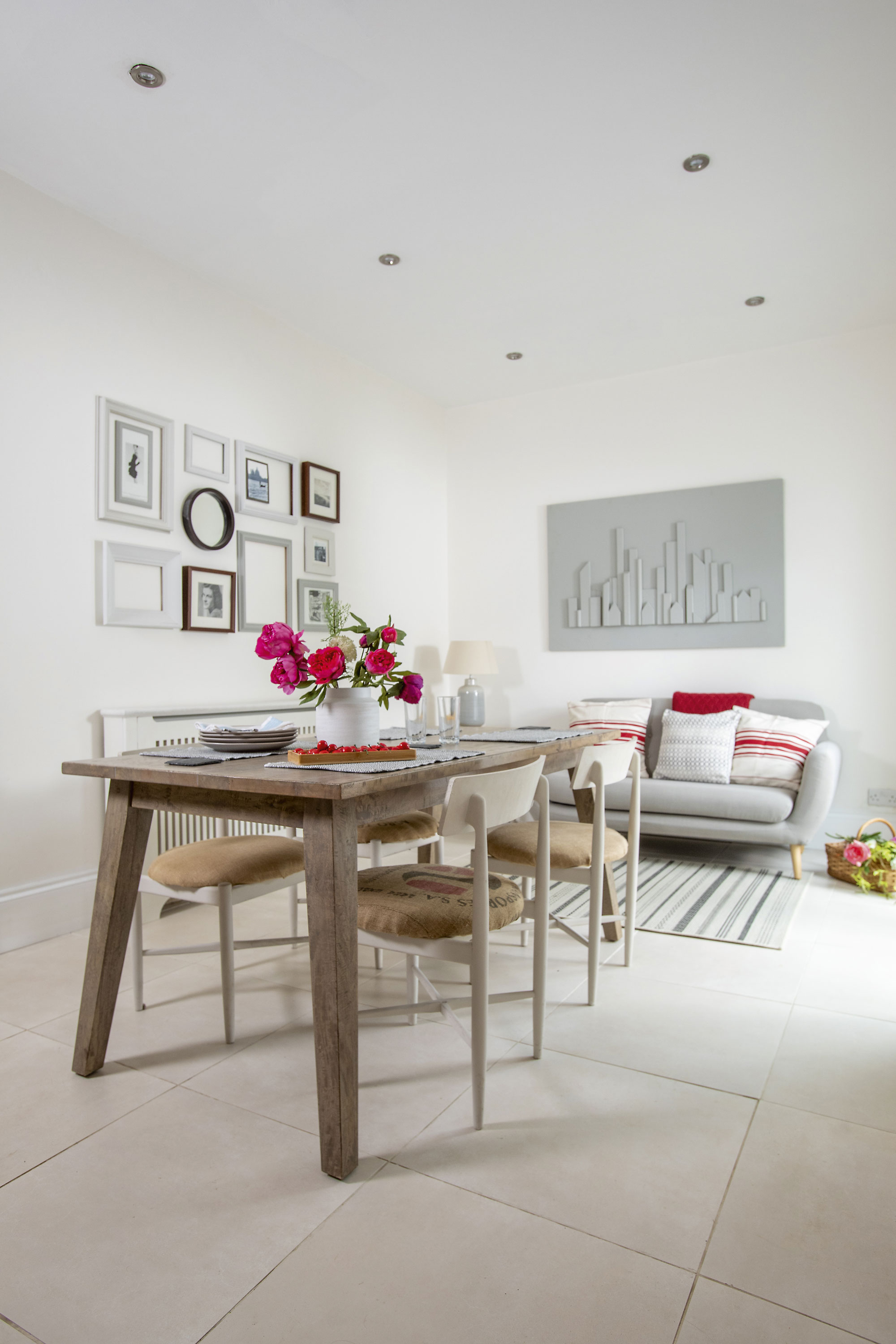 Kate teamed a modern table with second-hand chairs from a charity shop to furnish the dining room, and she added artwork by her mum to the walls