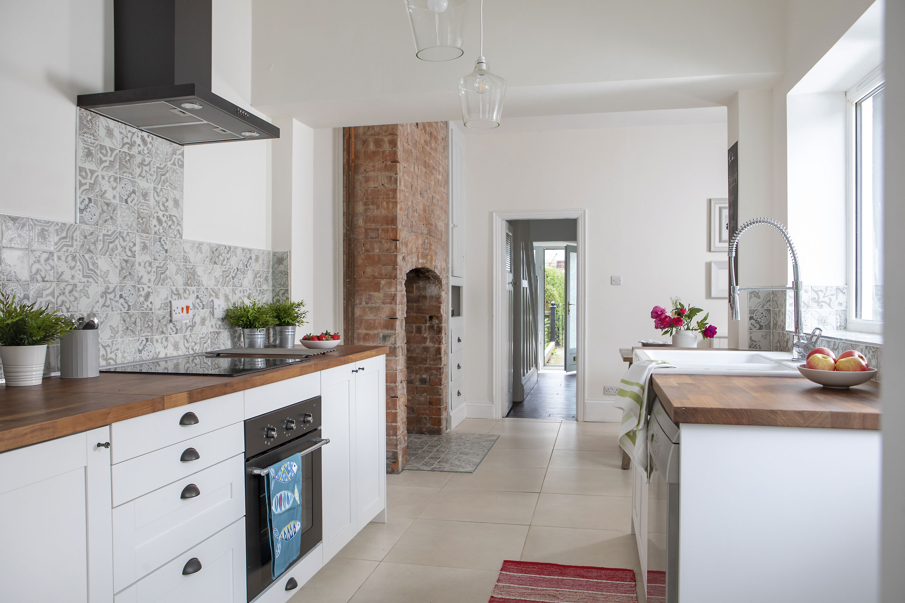 Wall cabinets could have made the narrow kitchen seem like a corridor, so Kate chose base units only to maximise the space