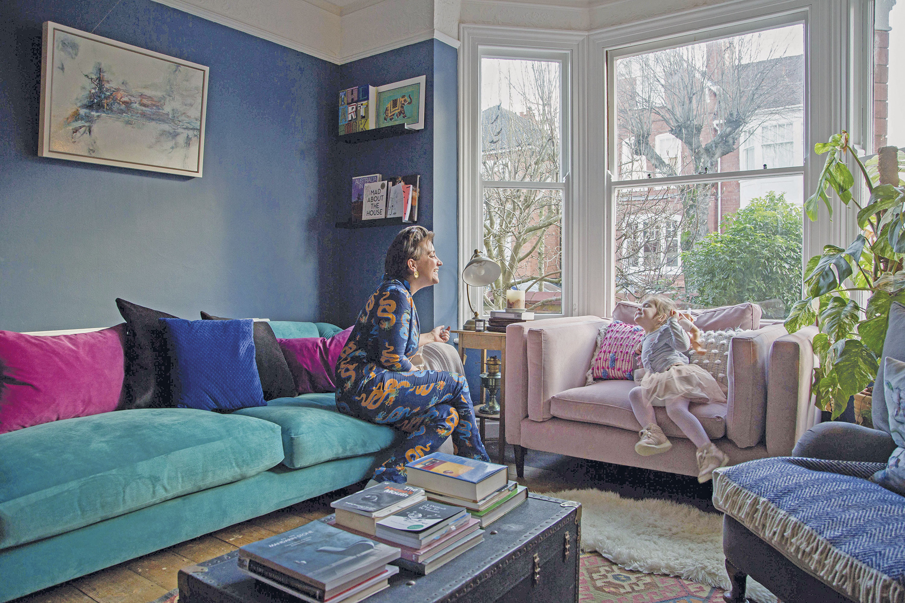 Megan prioritised comfy and cosy living when designing the living room. The dark tones teamed with the log-burner and mix of textures creates a snug space for the family to unwind in