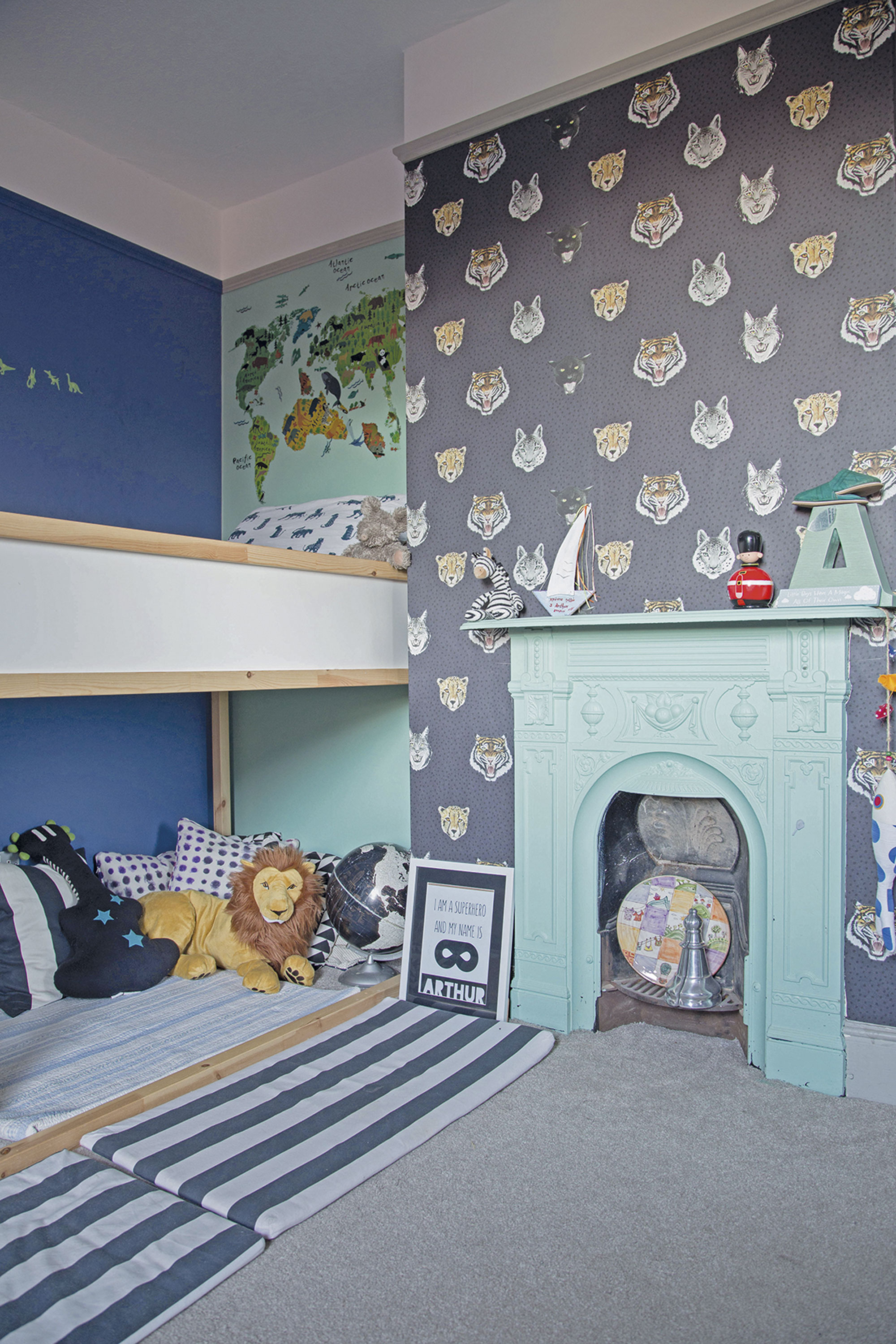 Megan involved Arthur in the design of his bedroom by allowing him to choose the wallpaper. The animal head motifs paired with dark and aqua blue wall paints create a smart, yet fun scheme Megan involved Arthur in the design of his bedroom by allowing him to choose the wallpaper. The animal head motifs paired with dark and aqua blue wall paints create a smart, yet fun scheme
